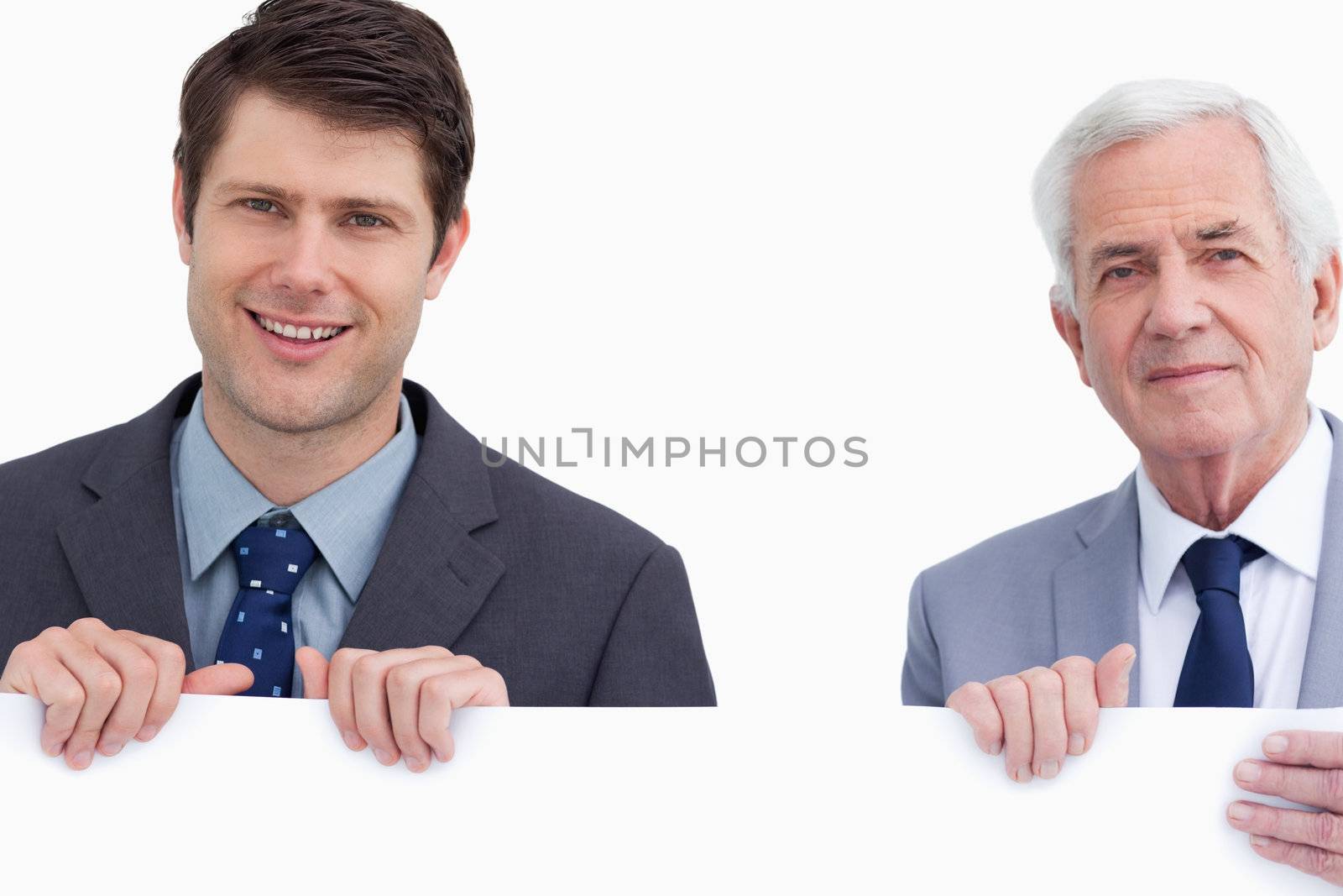Close up of businessman holding blank sign against a white background
