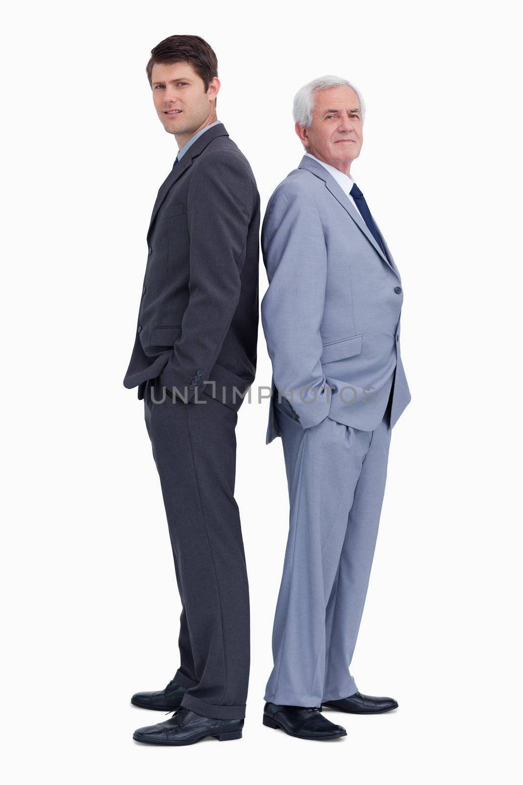 Businessman standing back to back with his mentor against a white background