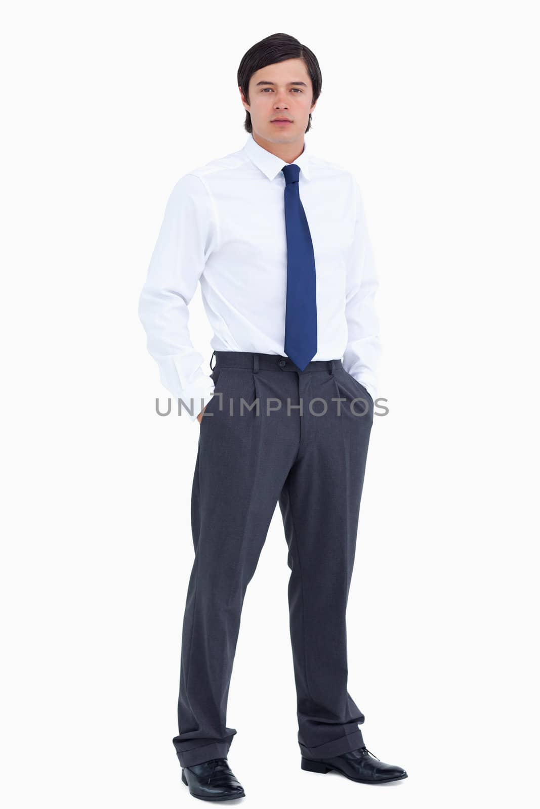 Tradesman with his hands in his pockets against a white background