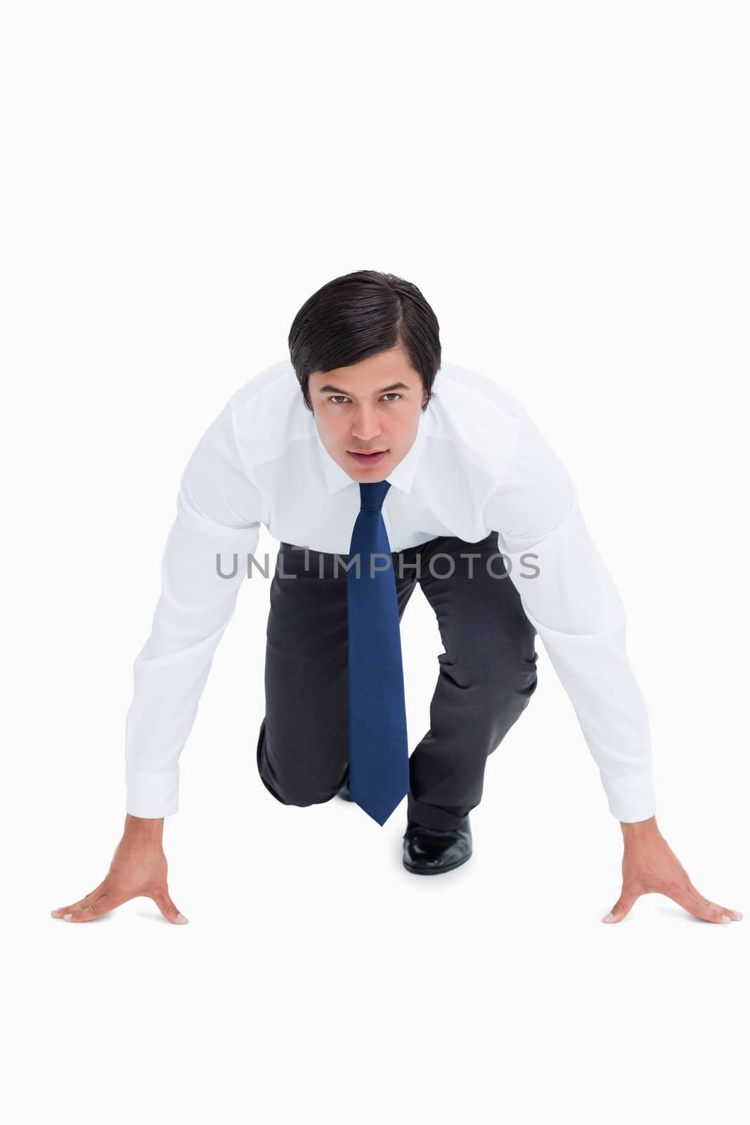 Tradesman in sprinting position against a white background