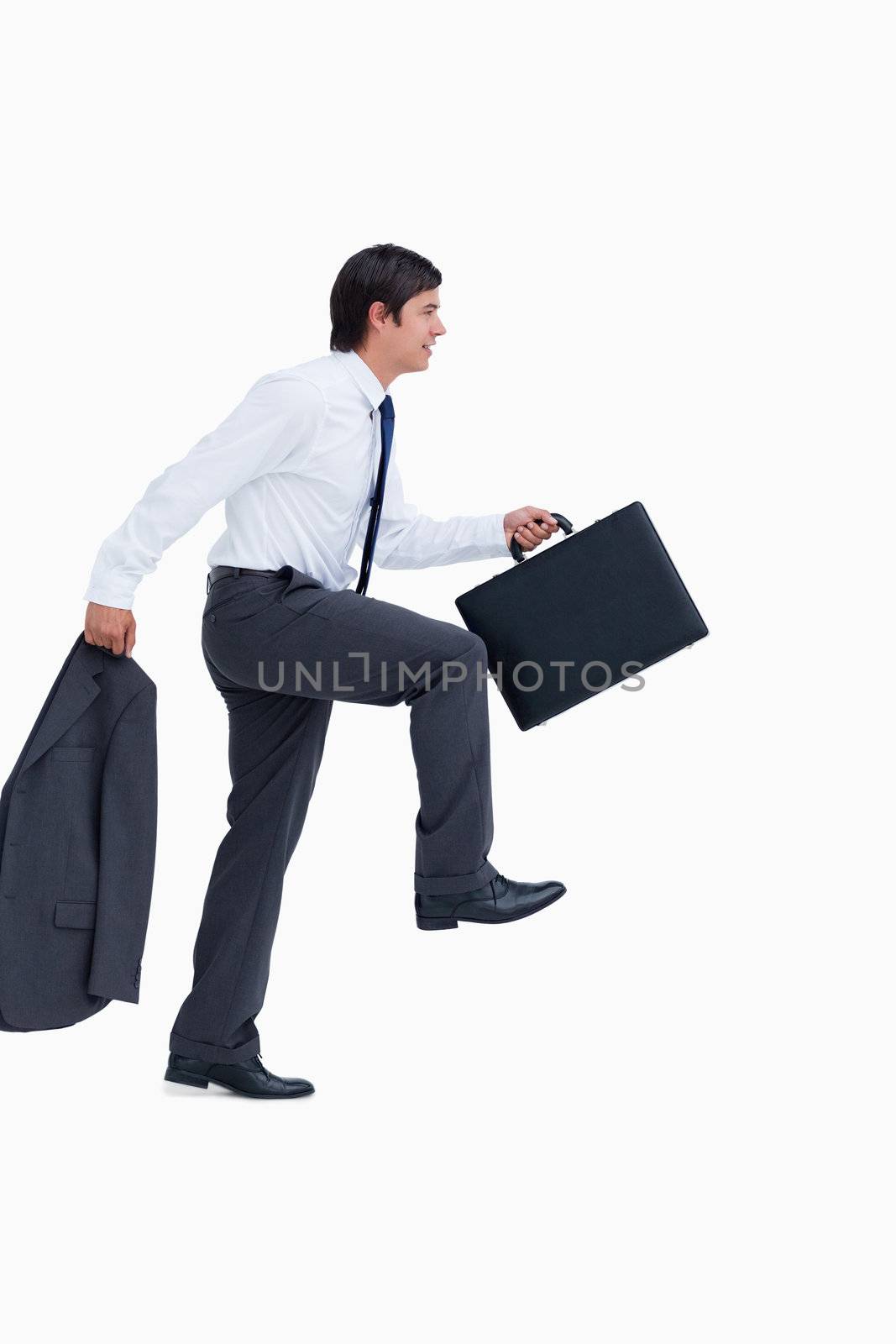 Side view of walking tradesman with jacket and suitcase against a white background