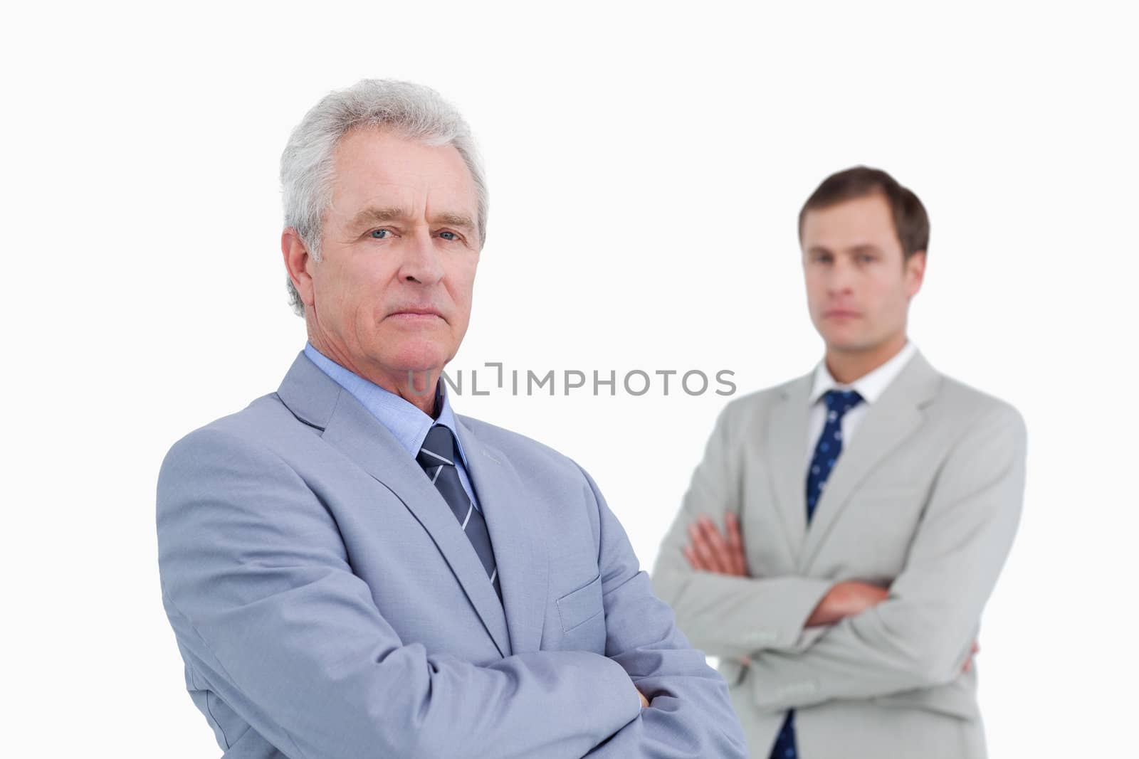 Serious tradesmen with arms folded against a white background