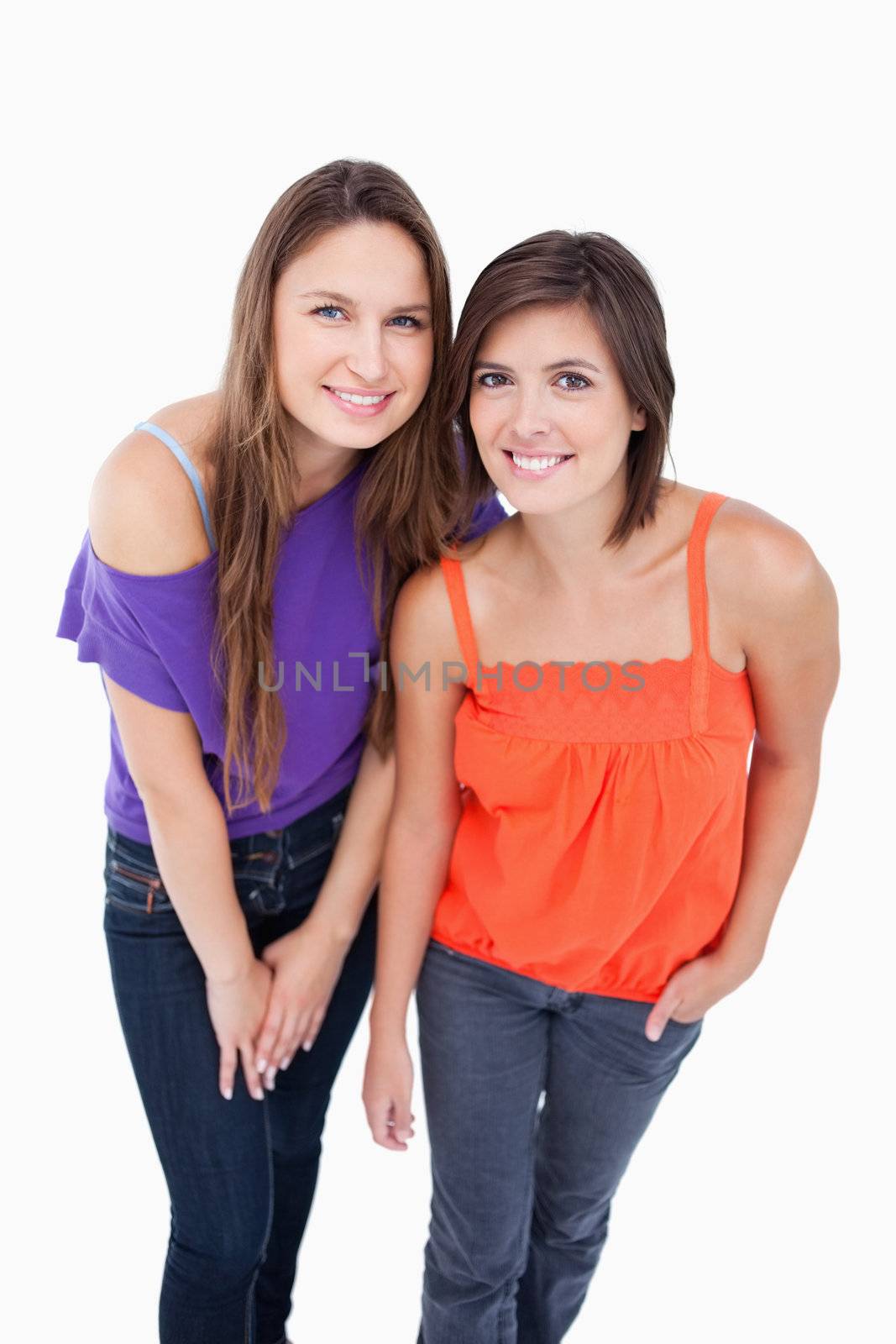 Two teenagers leaning their bodies forward