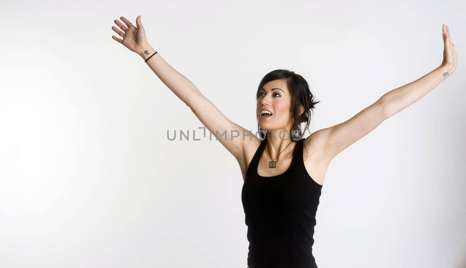 A woman holds her hands up and out to welcome the energy
