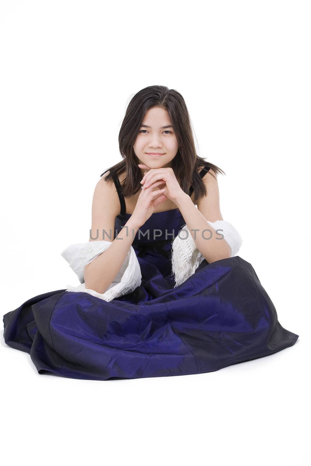 Young teen biracial girl in elegant, dark blue dress gown isolated on white