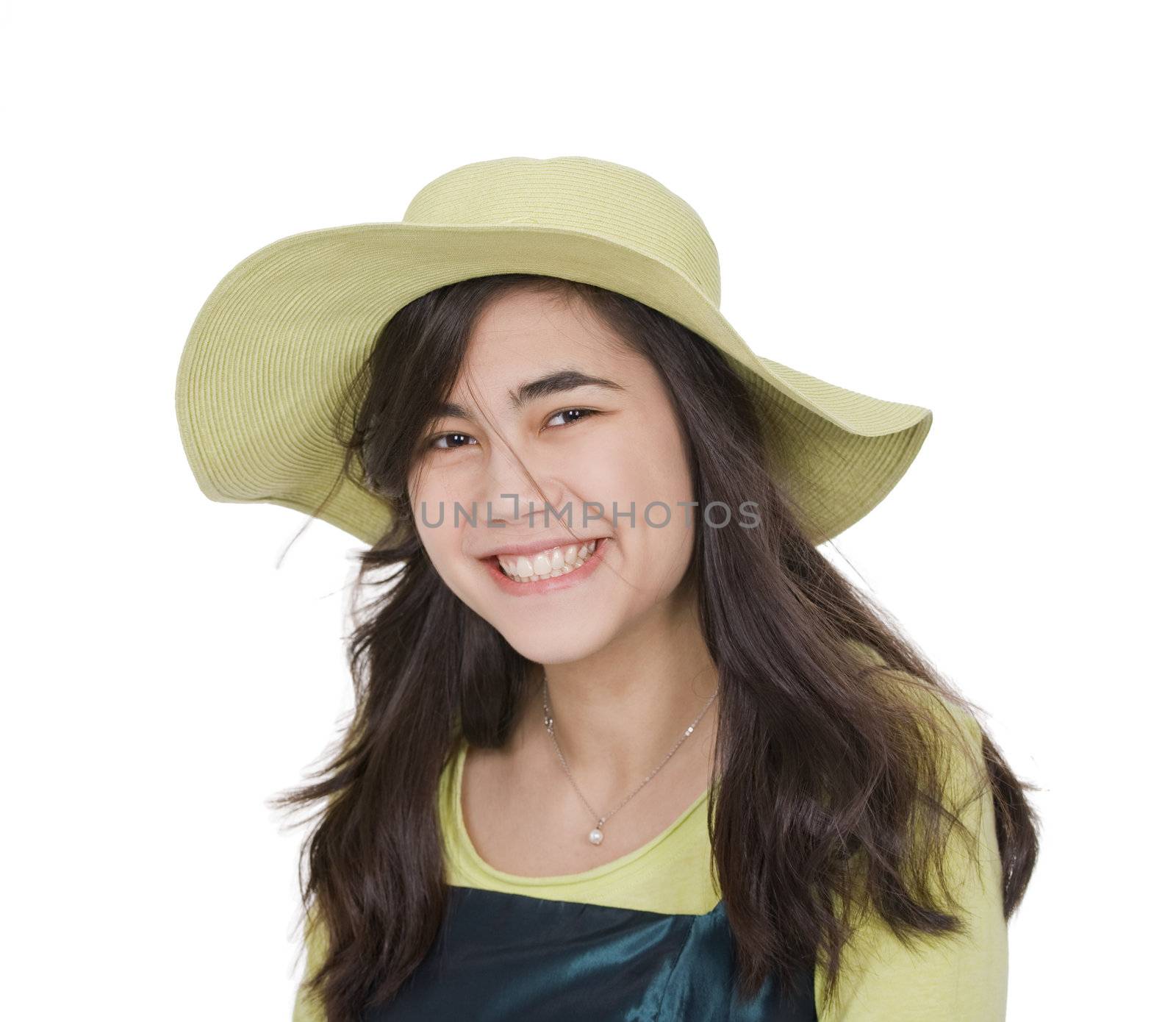 Smiling teen  biracial girl in green dress and lime green hat