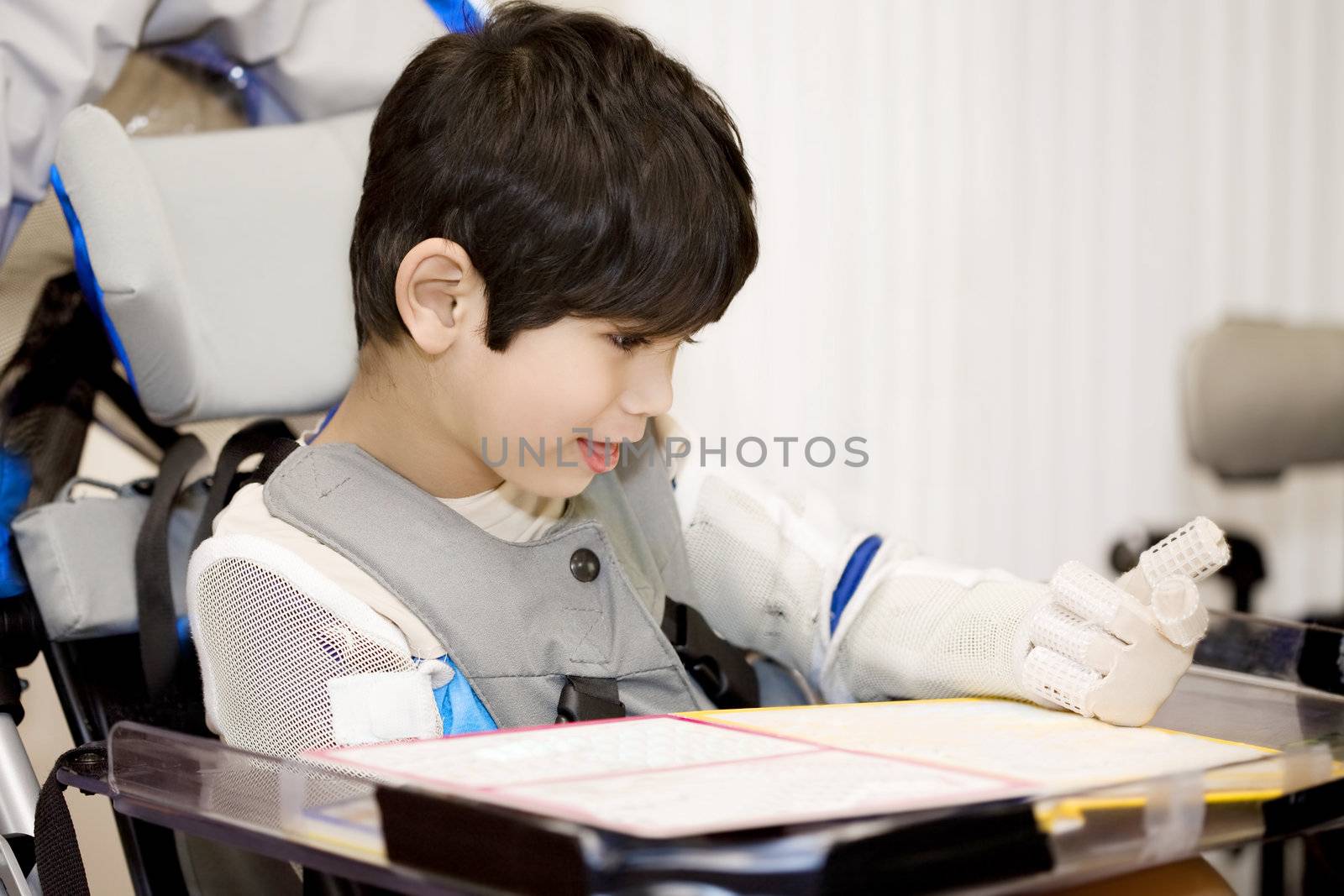 Five year old disabled boy studying in wheelchair by jarenwicklund