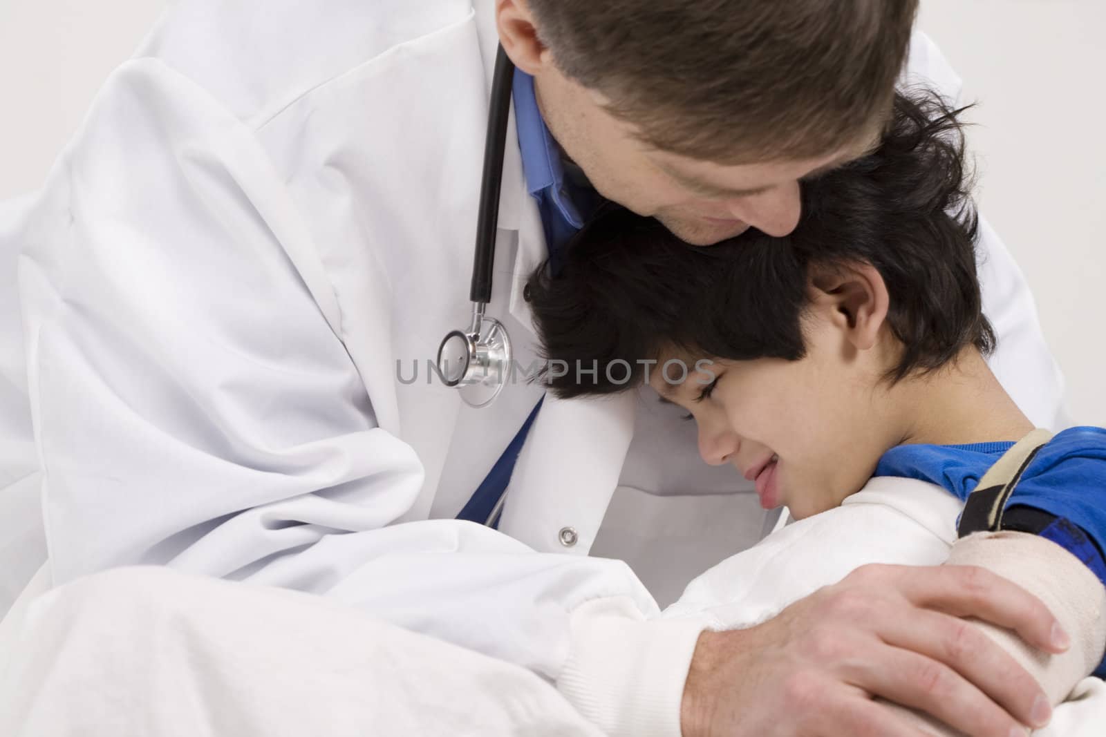 Male doctor comforting disabled  toddler patient  by jarenwicklund