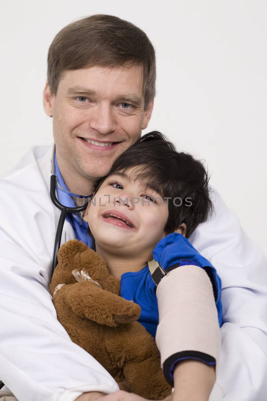 Male doctor comforting disabled  toddler patient on lap by jarenwicklund