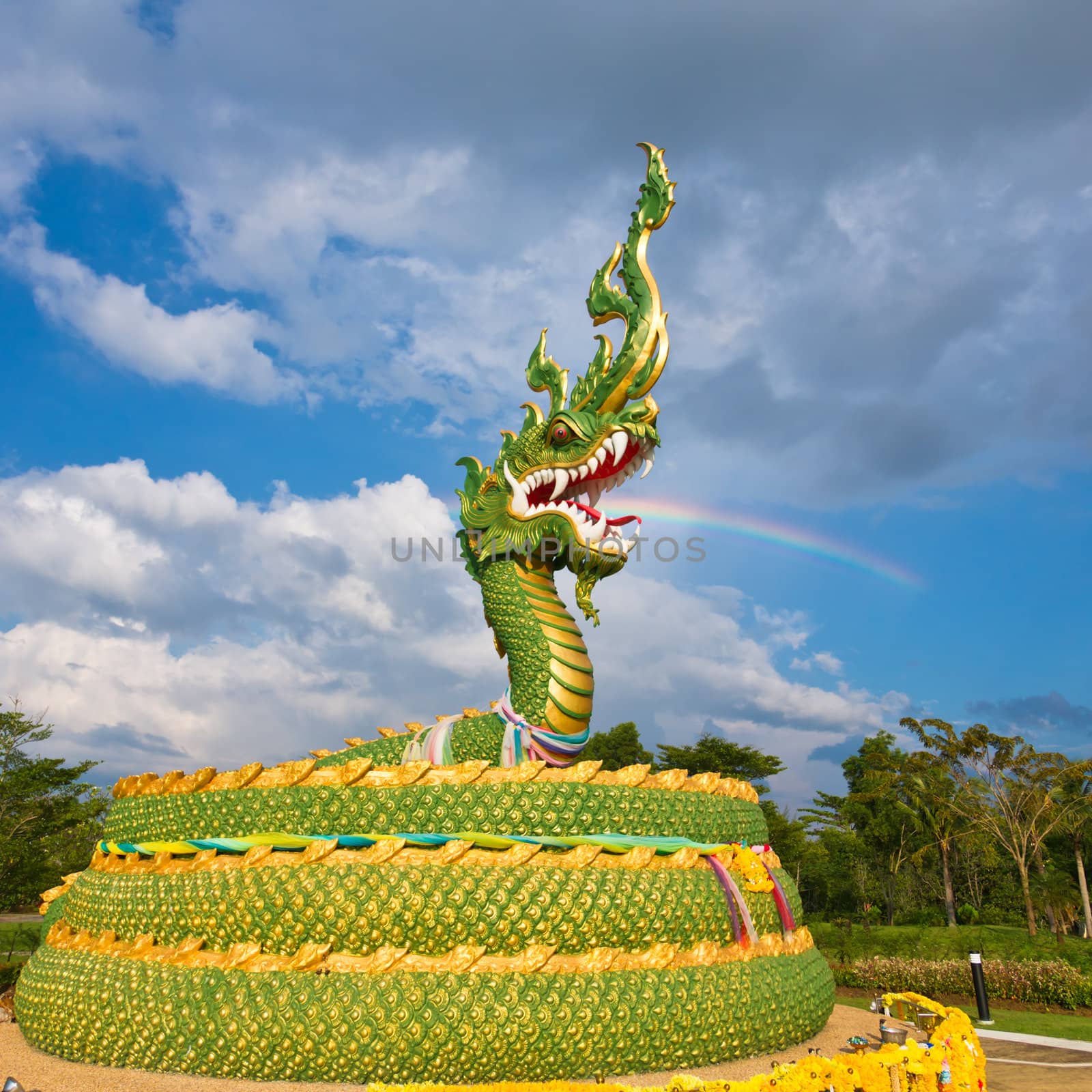 The statue of asian dragon on the cloudy sky background