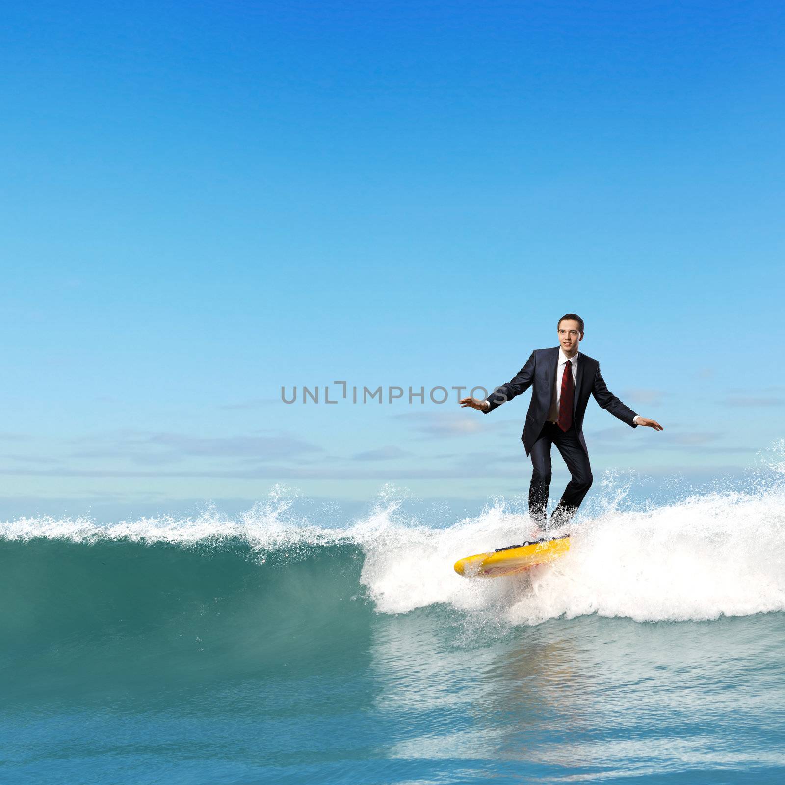 Businessman surfing on the waves of the ocean by sergey_nivens