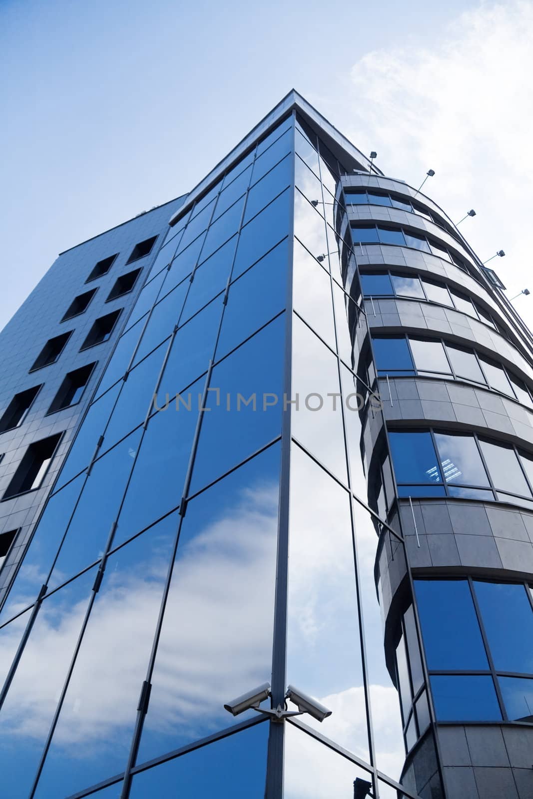 skyscraper window with bright blue sky reflected