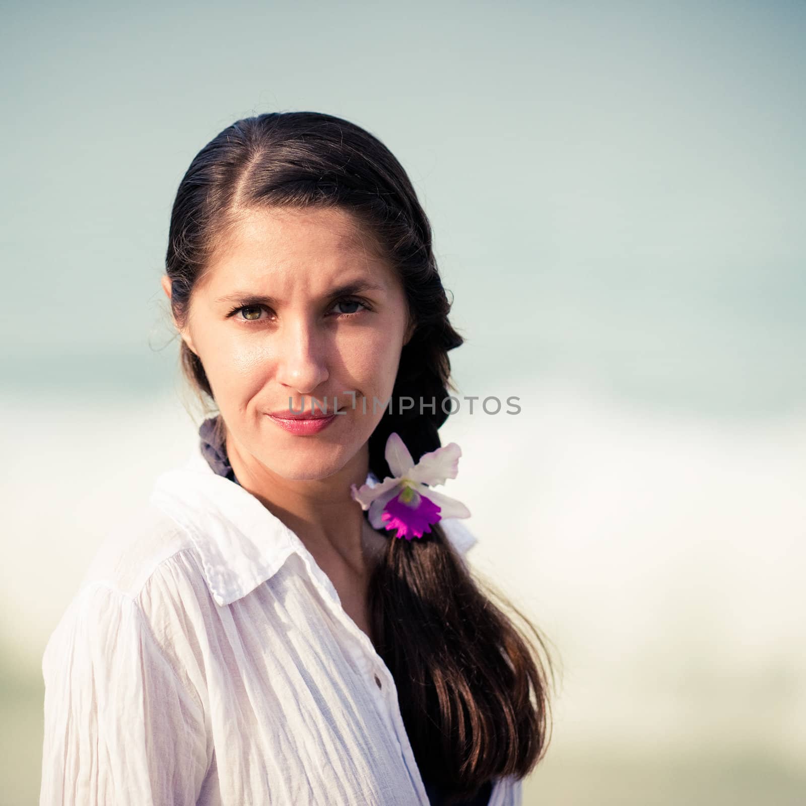 Portrait of young woman on the sky background