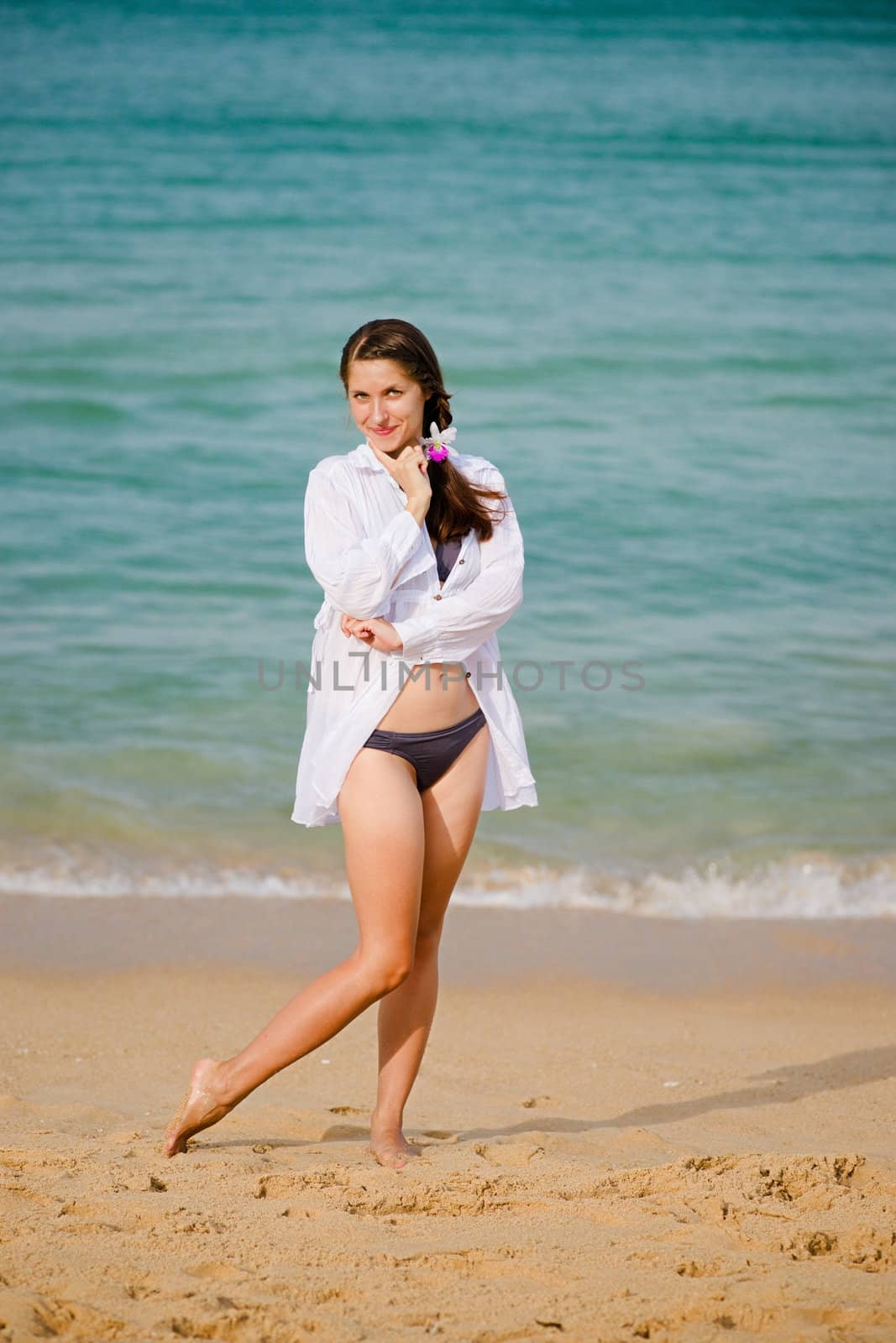 Young woman standing on the beach