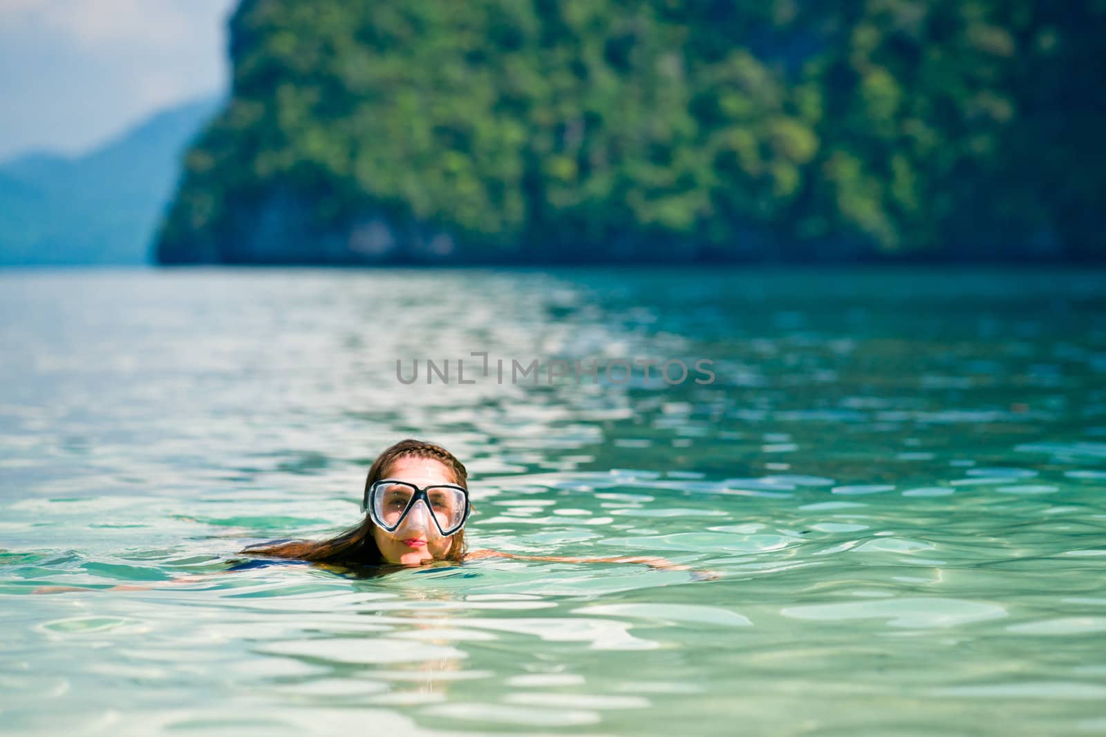 Woman with mask swimming in the sea