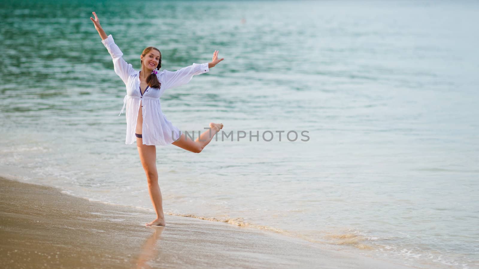 Young woman dancing in the sea