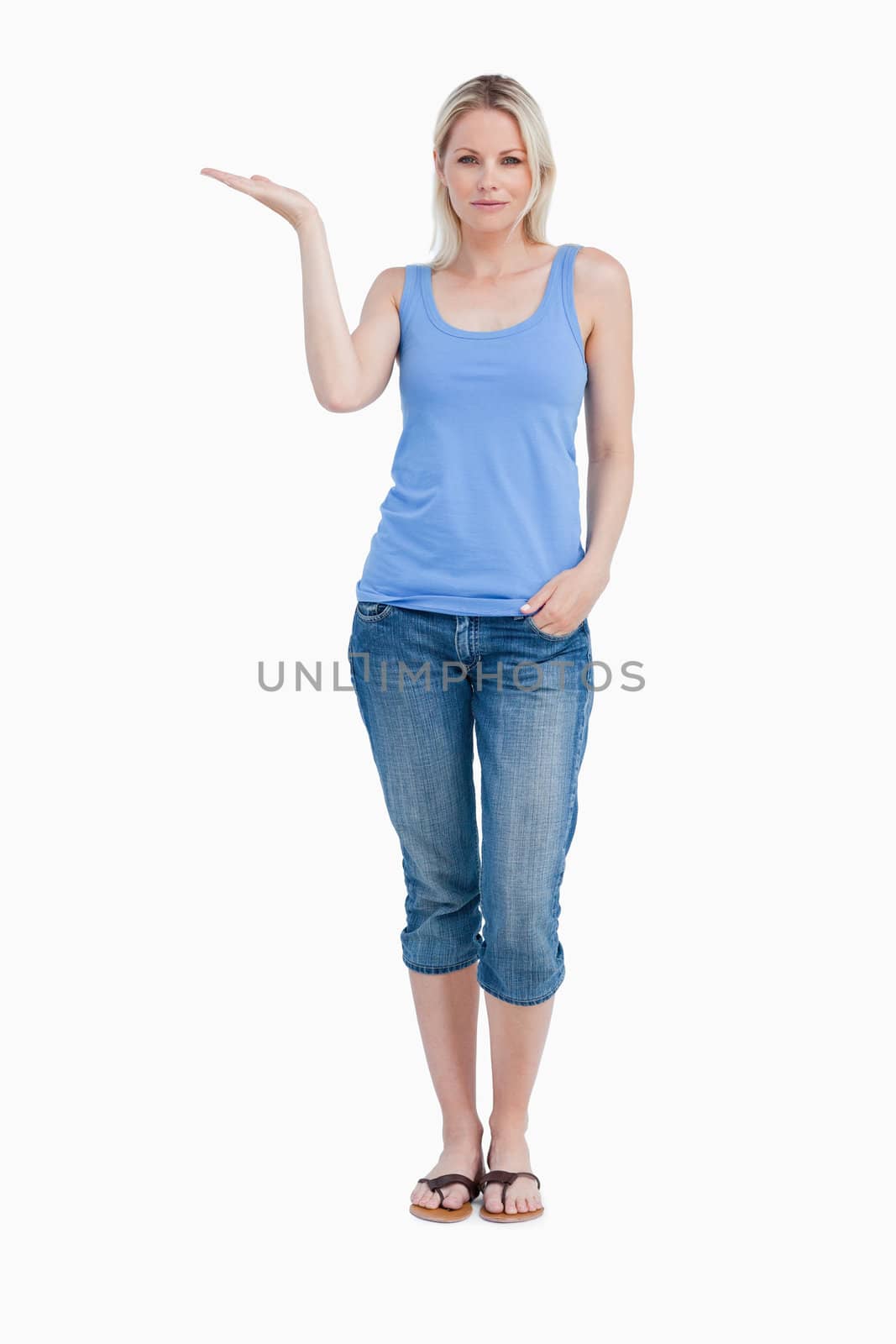 Relaxed blonde woman placing her hand palm up against a white background