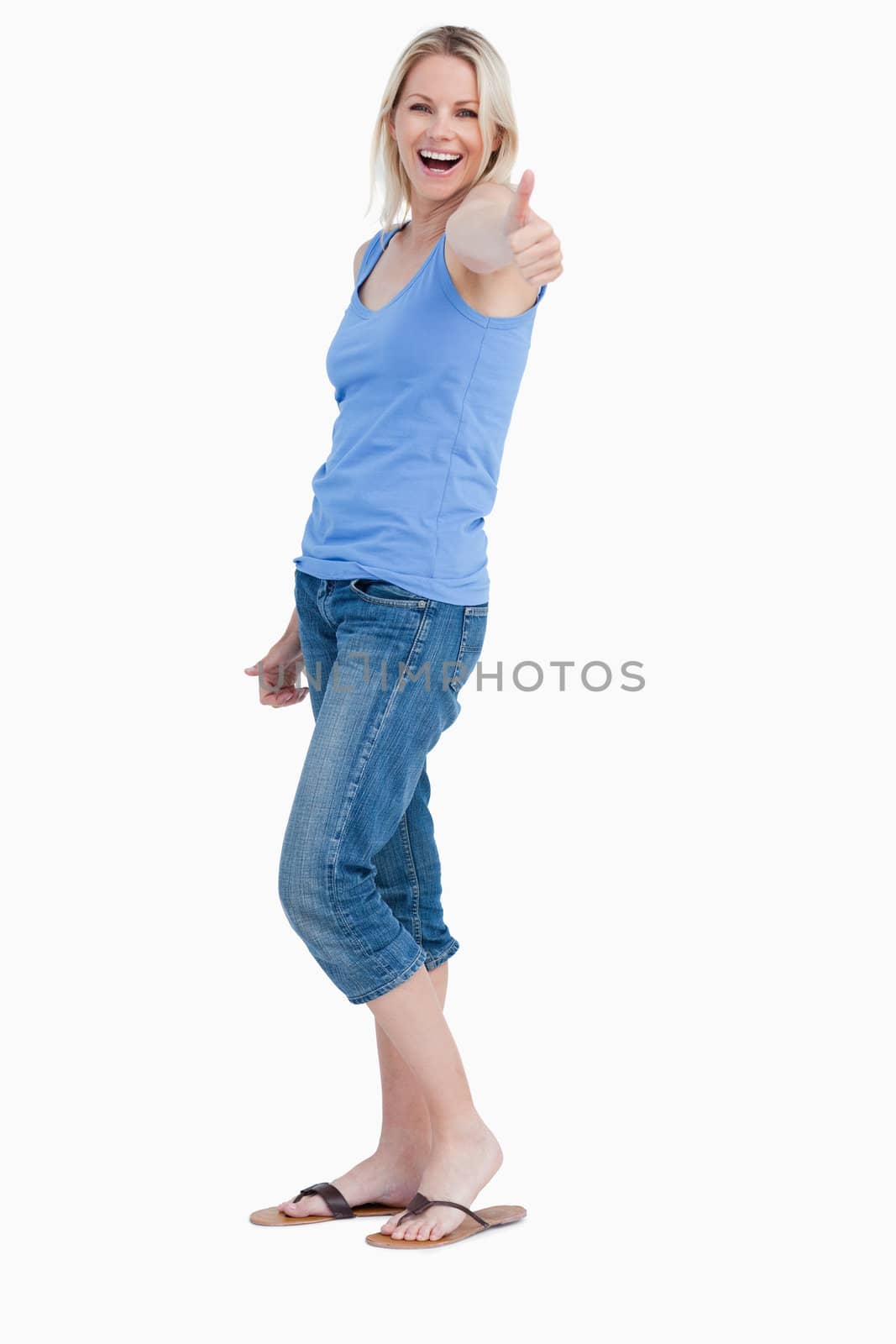 Side view of a laughing woman showing her thumbs up against a white background