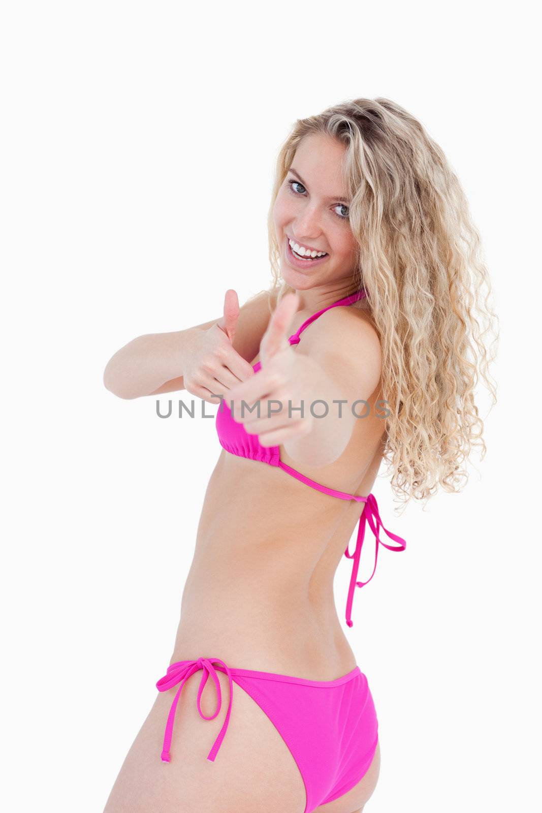 Attractive teenager showing thumbs up on her side