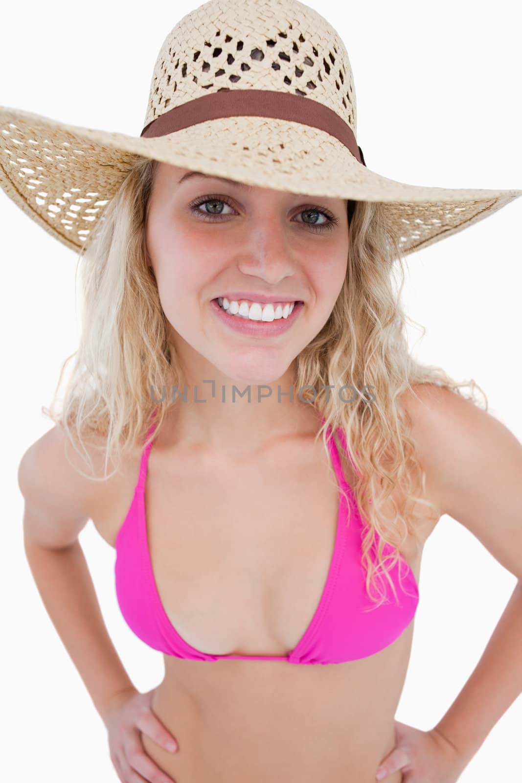 Attractive young blonde woman looking at the camera against a white background