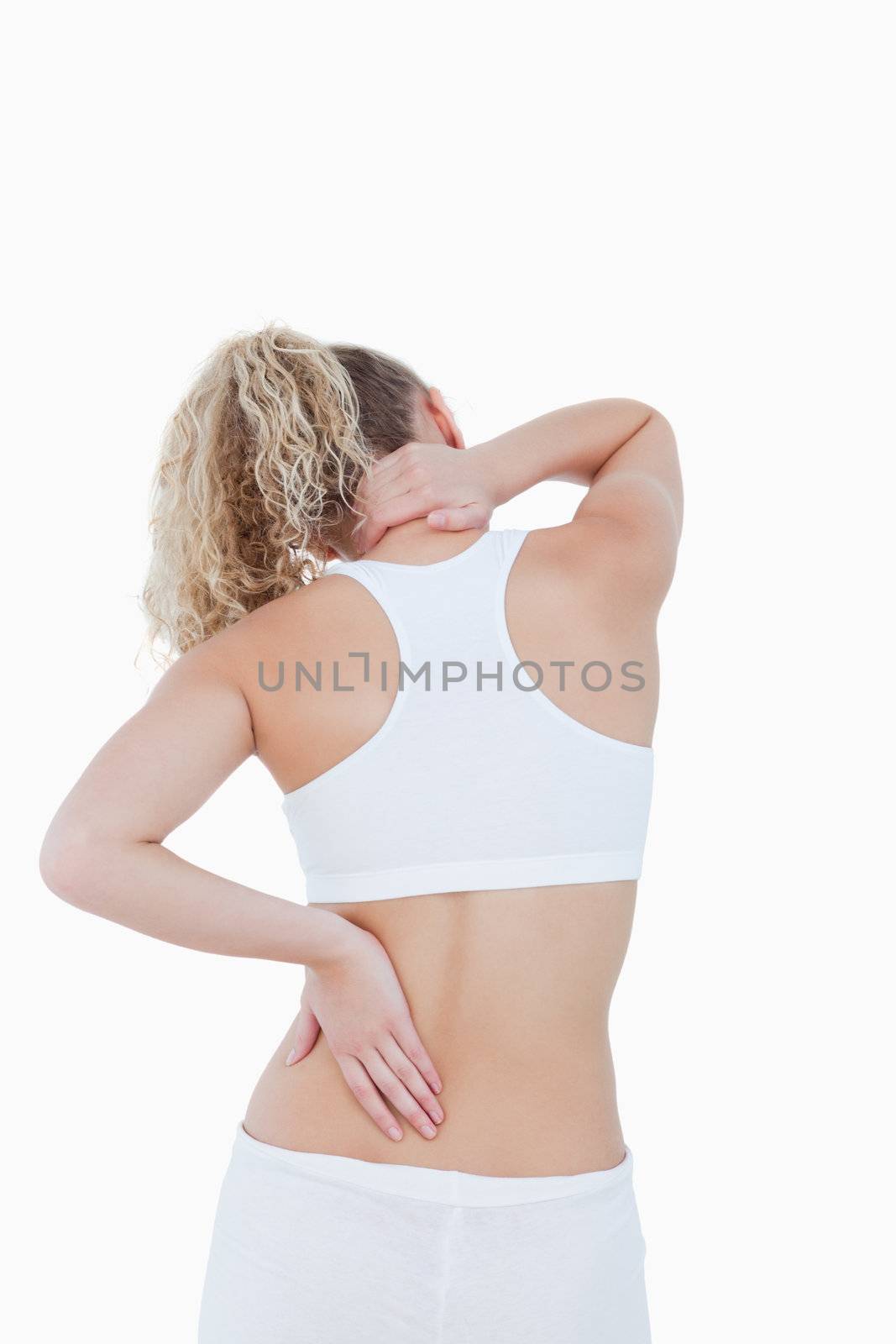 Blonde woman touching her painful neck and back against a white background
