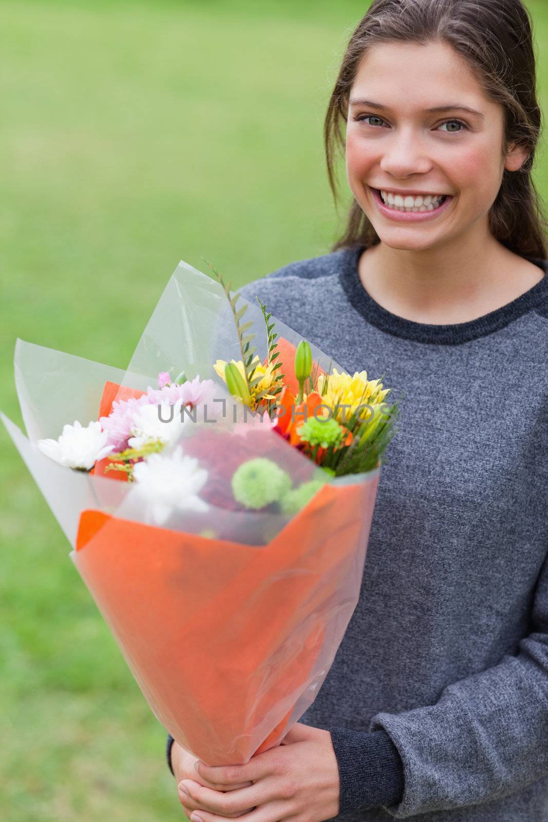 Young girl holding a beautiful bunch of flowers