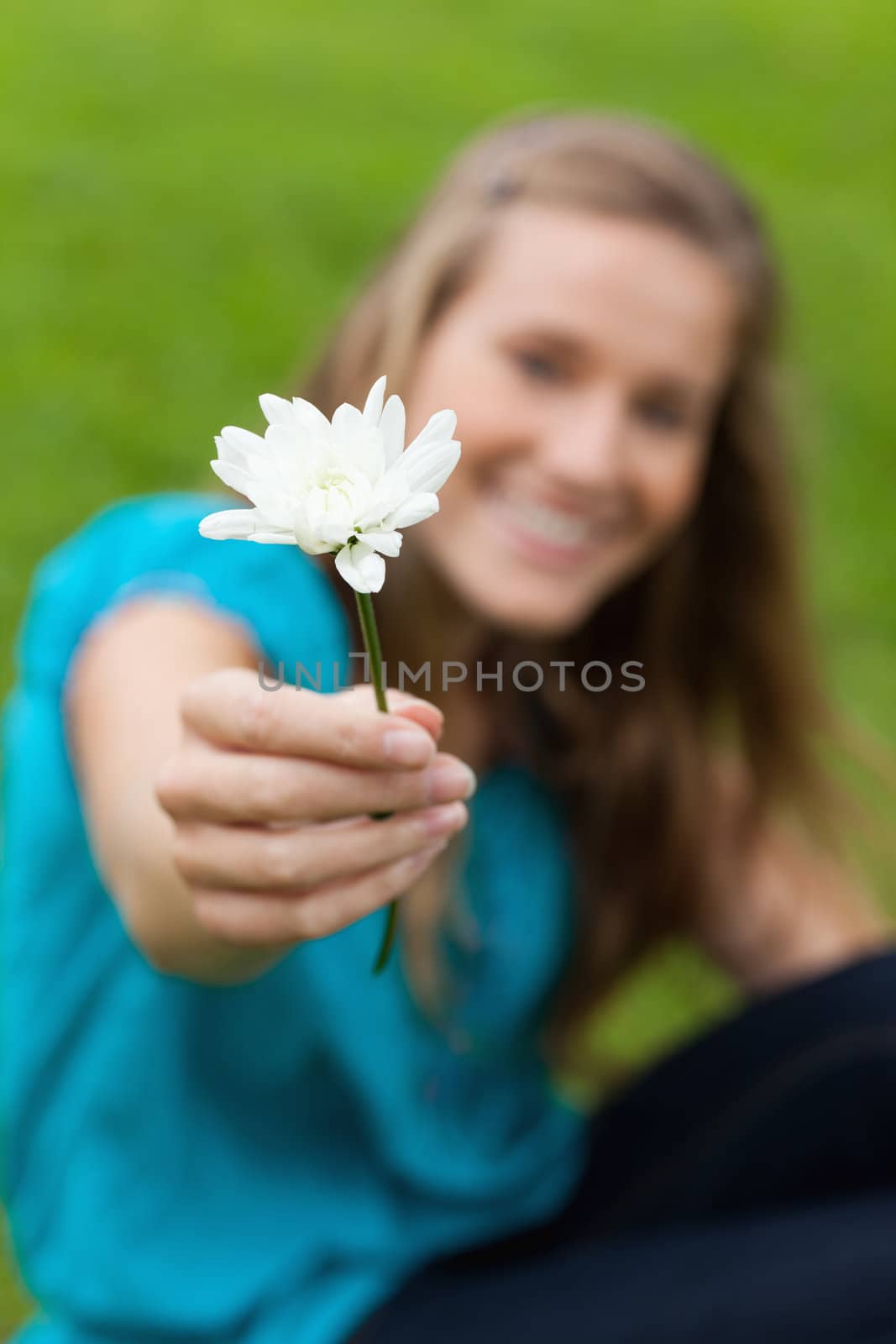 Beautiful white flower held by an attractive young woman by Wavebreakmedia