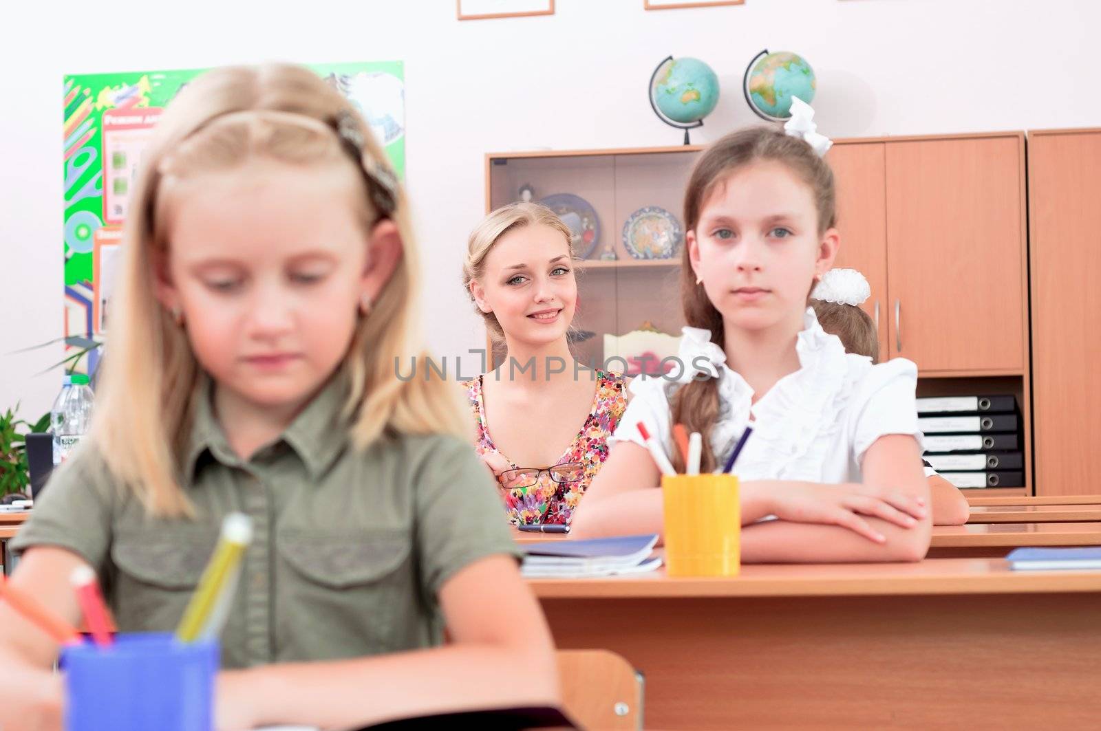portrait of students in the classroom, sit at school desks