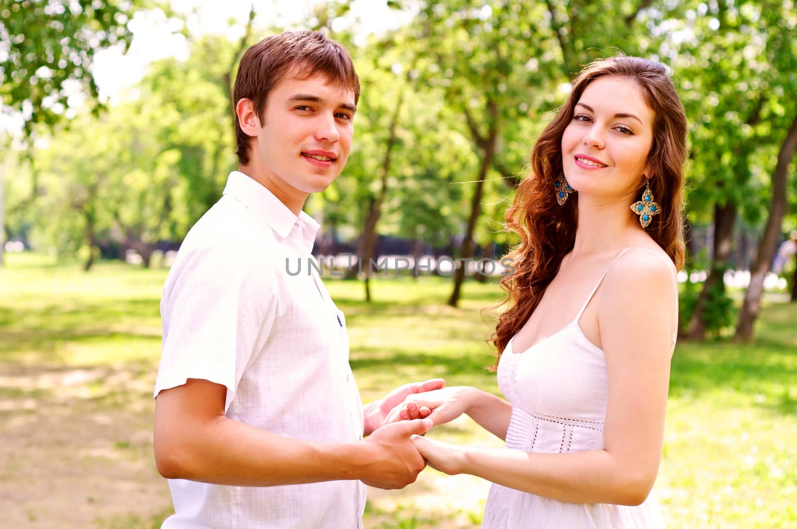 couple holding hands in the park by adam121