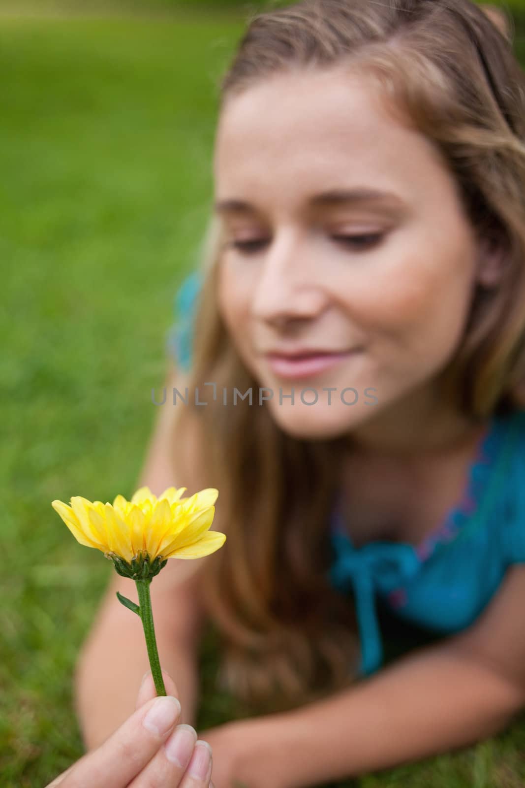 Beautiful yellow flower held by an attractive young girl