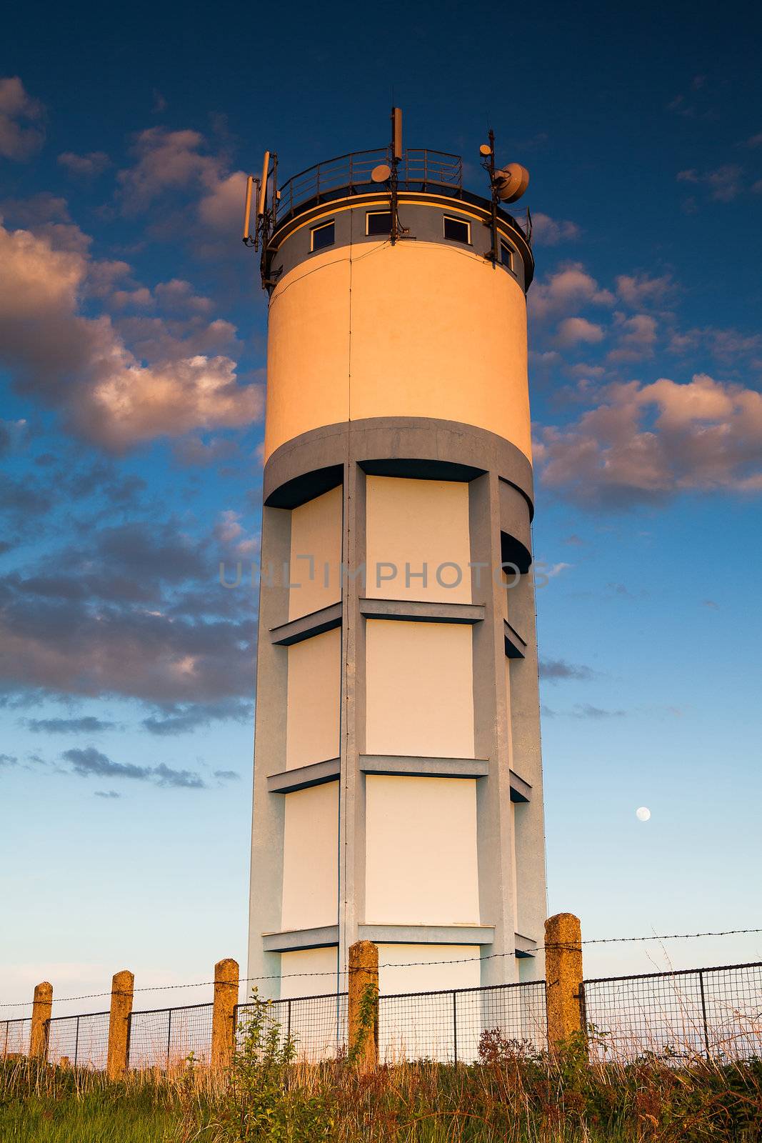 Historic water reservoir brick tower at sunset