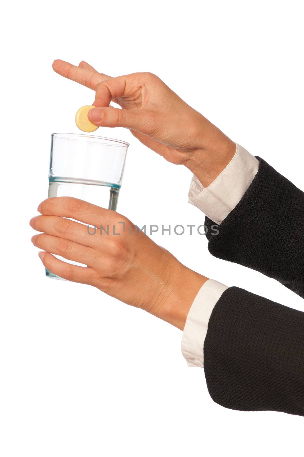 Businesswoman throws a pill from headache to the glass with water