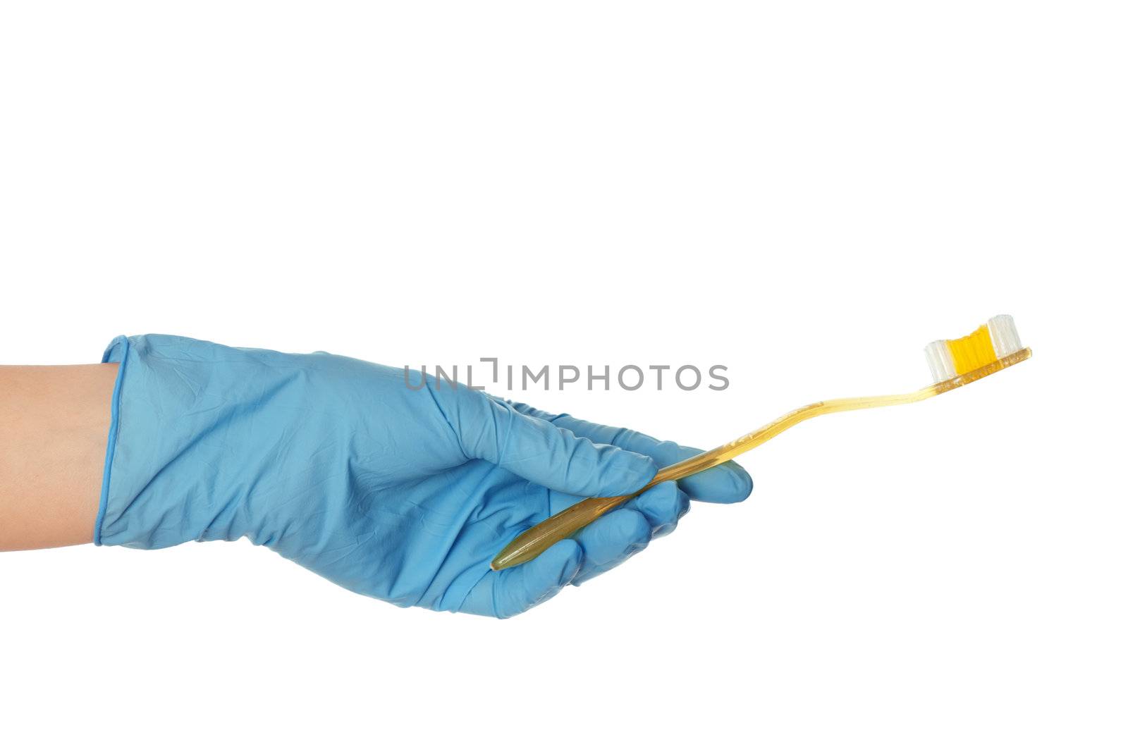 yellow brush for toothpaste in the doctor's hand