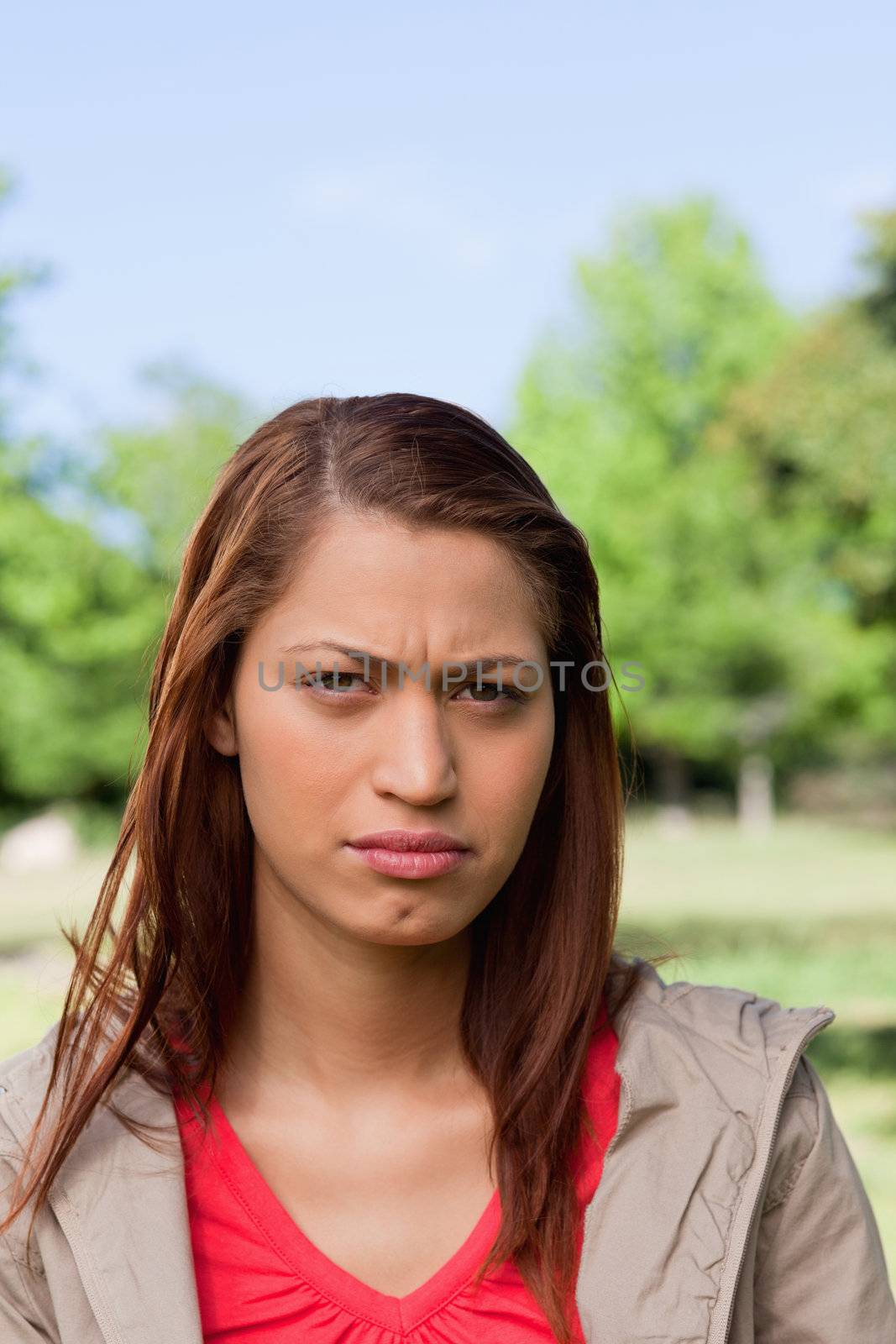Woman looking directly in front of her with a stern expression on her face