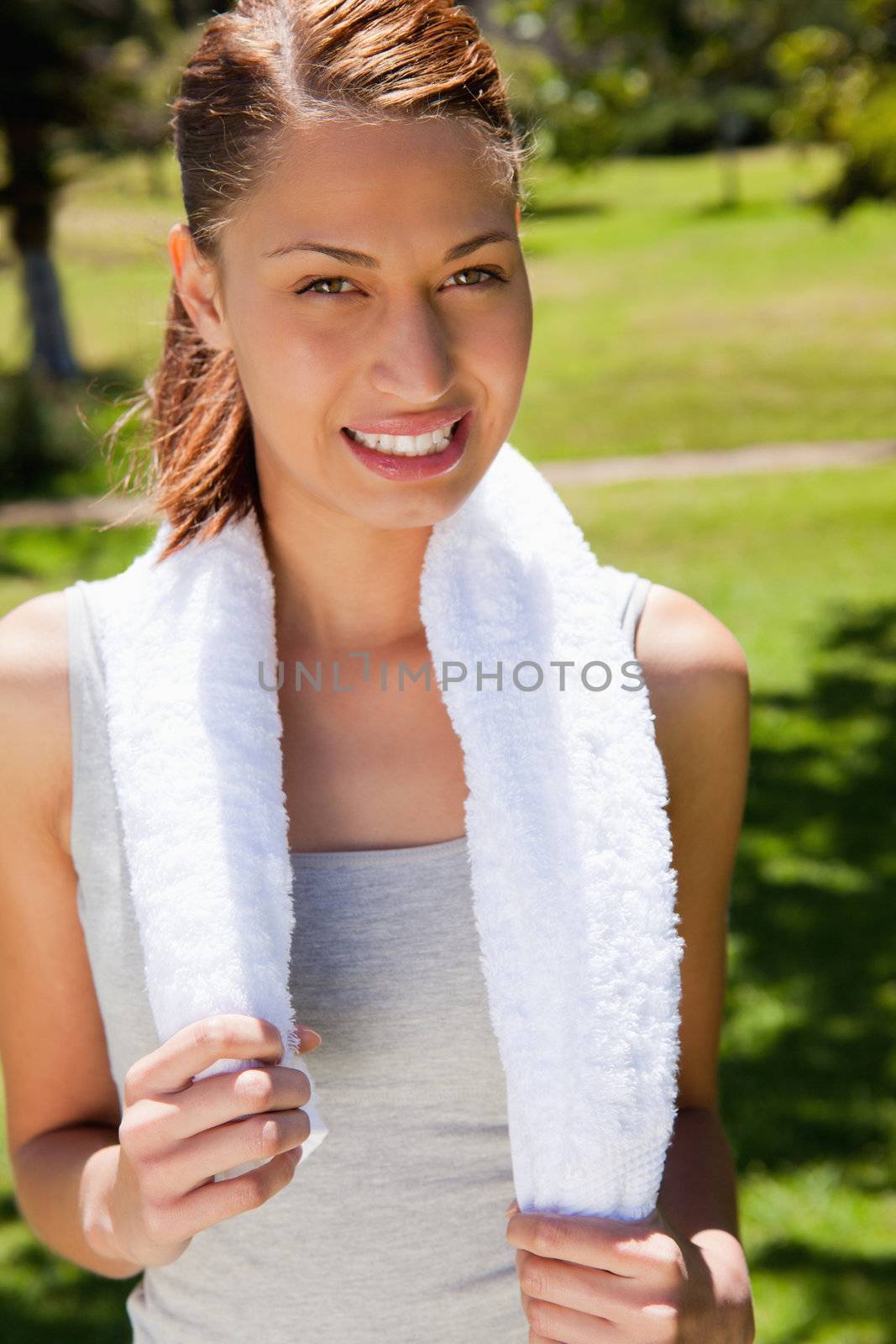 Smiling woman holding a towel by Wavebreakmedia