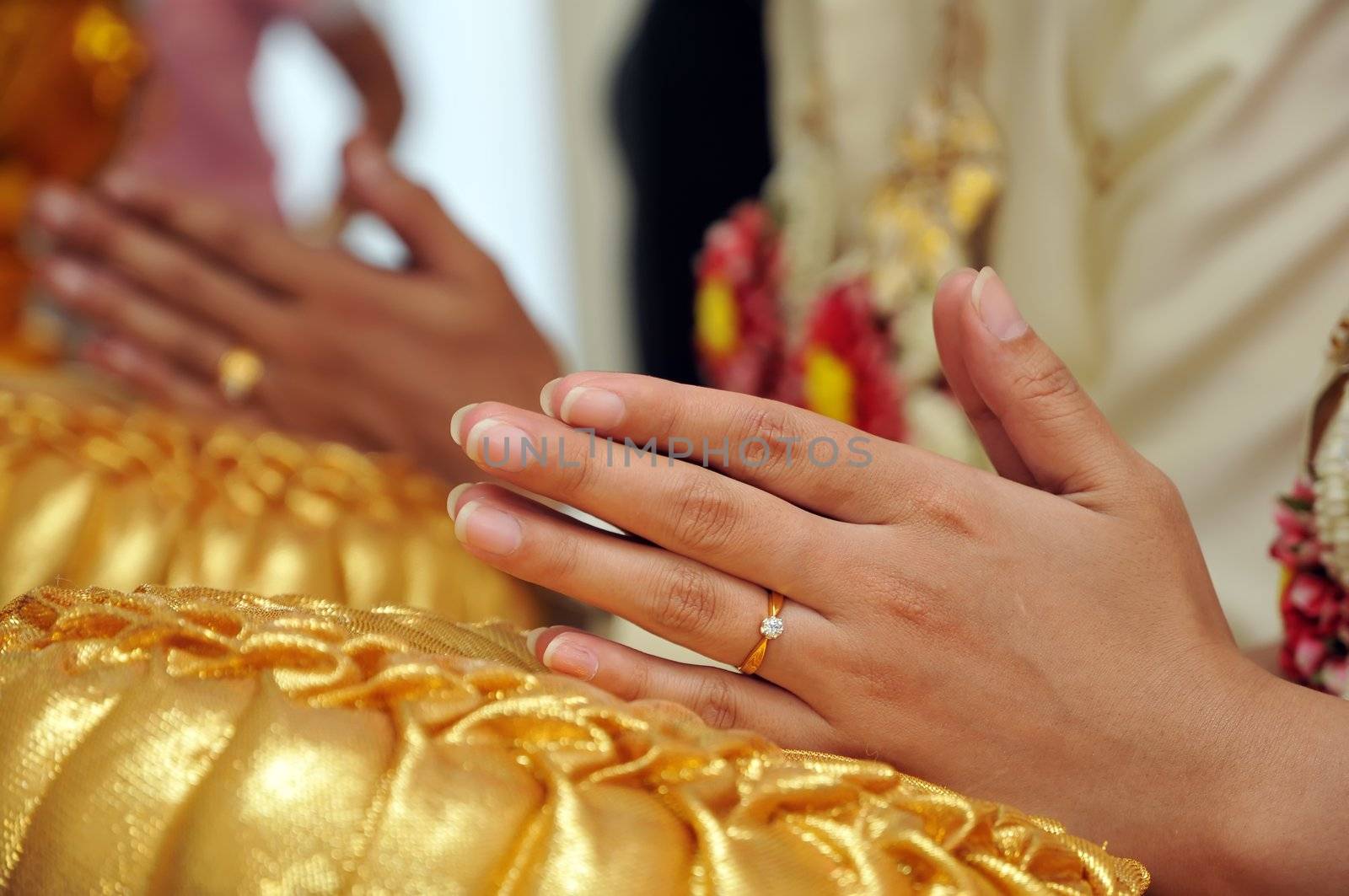 Thai wedding style ceremony with bride and groom hand