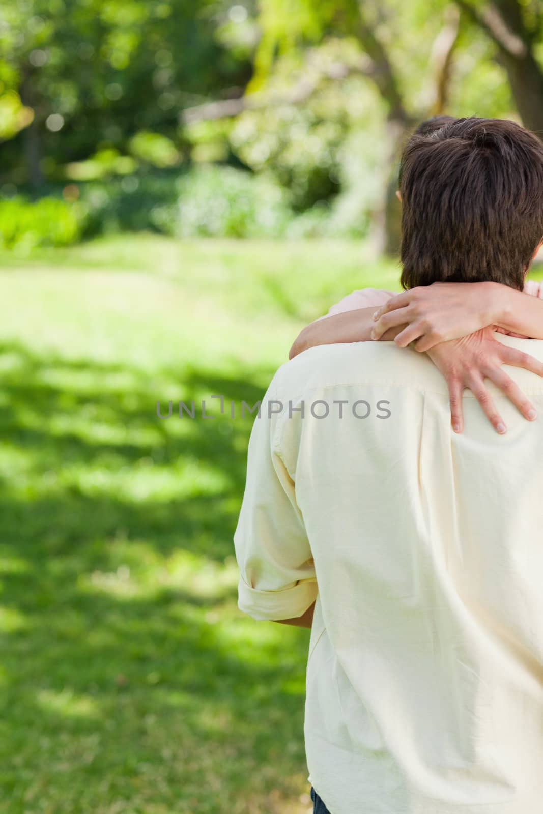 Man with his friends arms holding the back of his neck by Wavebreakmedia
