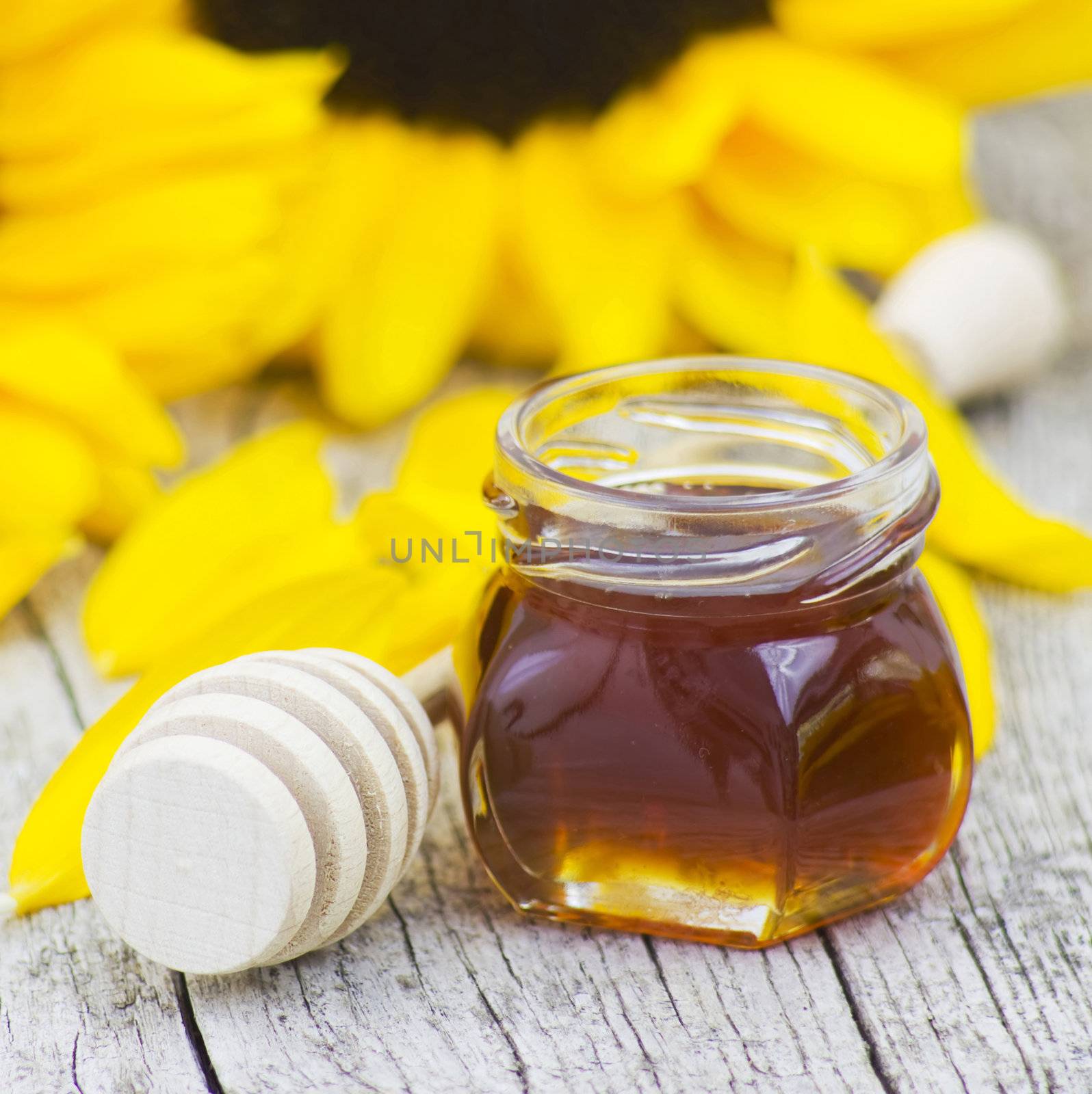 honey and sunflower on old wooden background