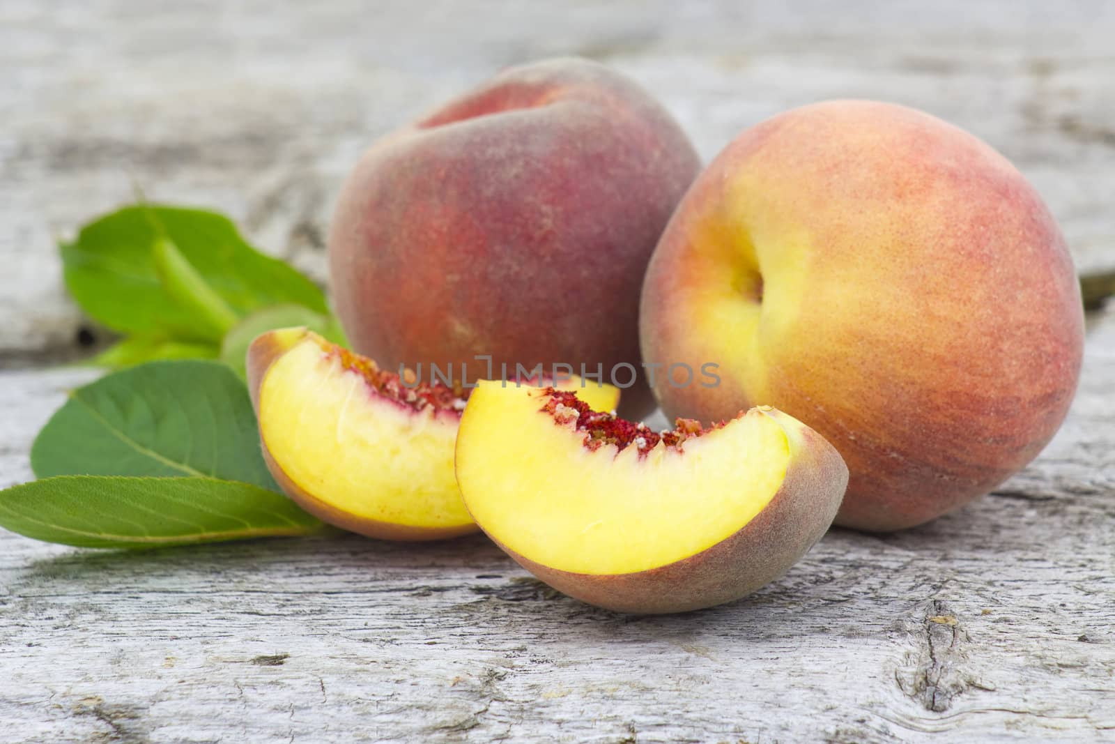 Fresh peaches on old wooden background