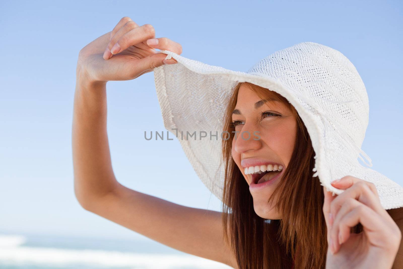 Young attractive woman screaming of joy in front of the sea by Wavebreakmedia