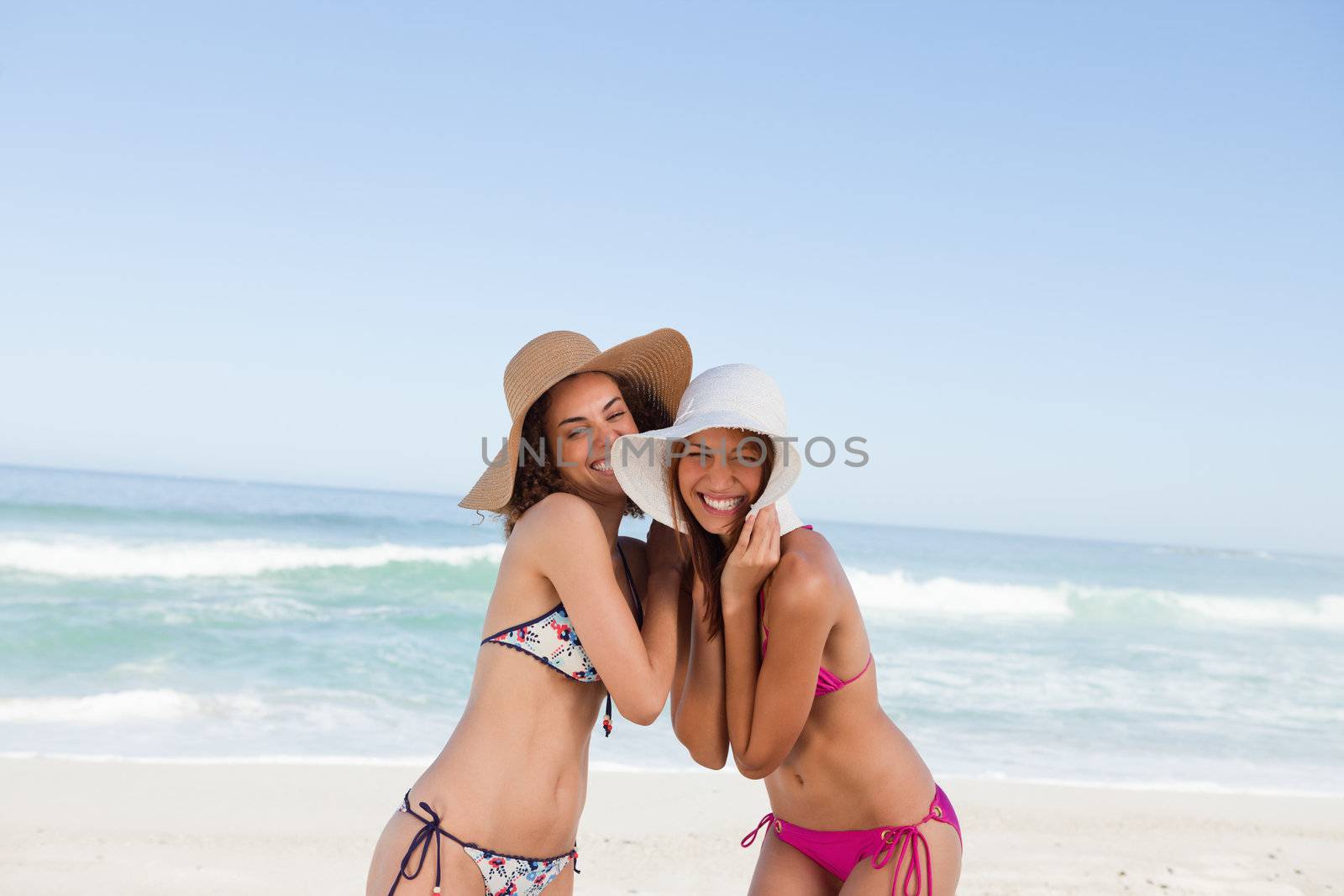 Smiling teenage girls having fun on the beach by Wavebreakmedia