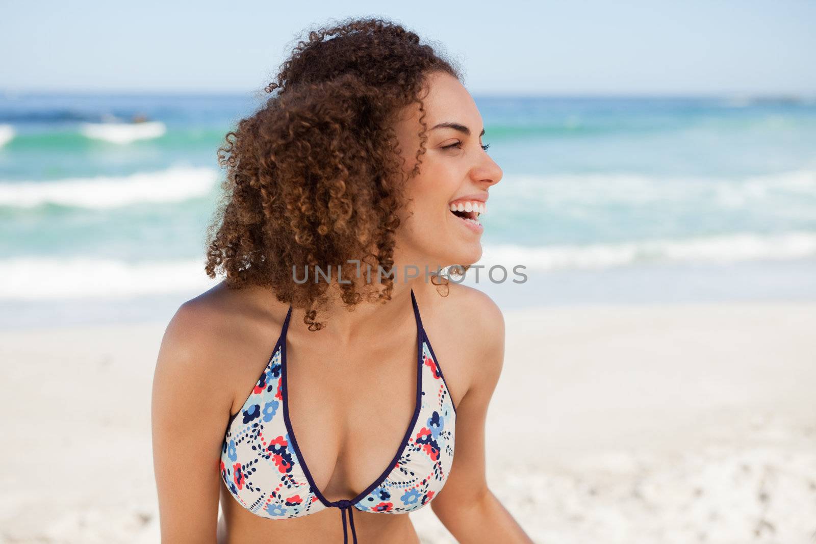 Young attractive woman looking on the side while standing on the by Wavebreakmedia