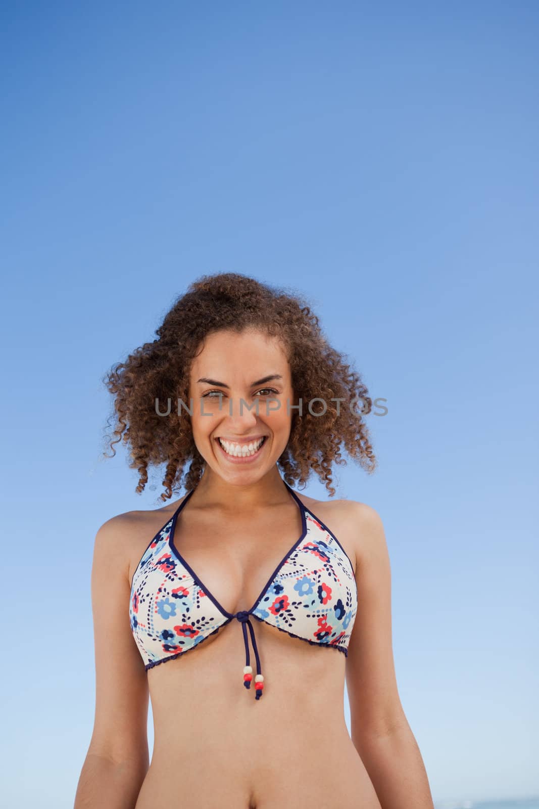 Young woman showing a beaming smile in front of the camera by Wavebreakmedia
