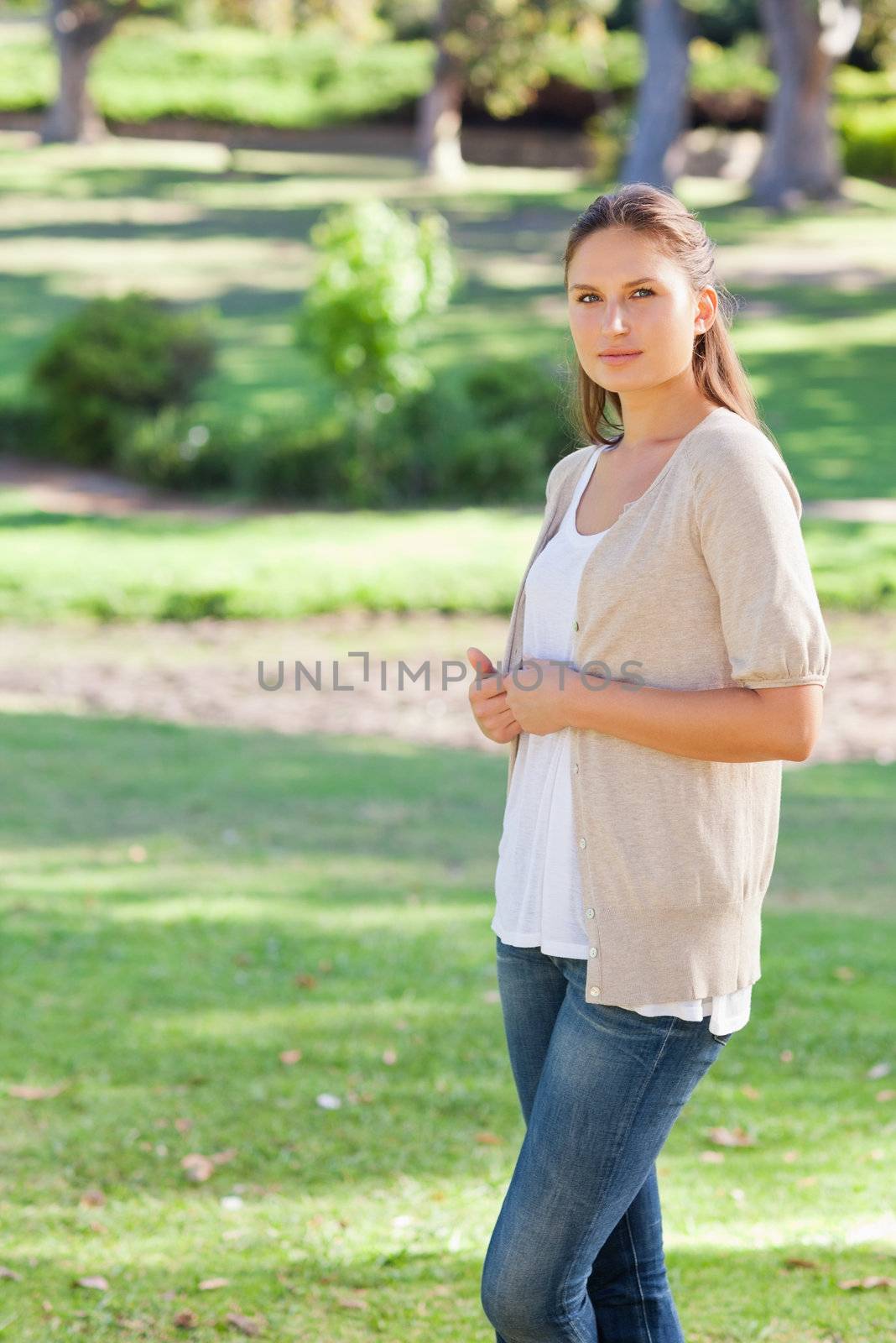 Side view of woman standing in the park by Wavebreakmedia