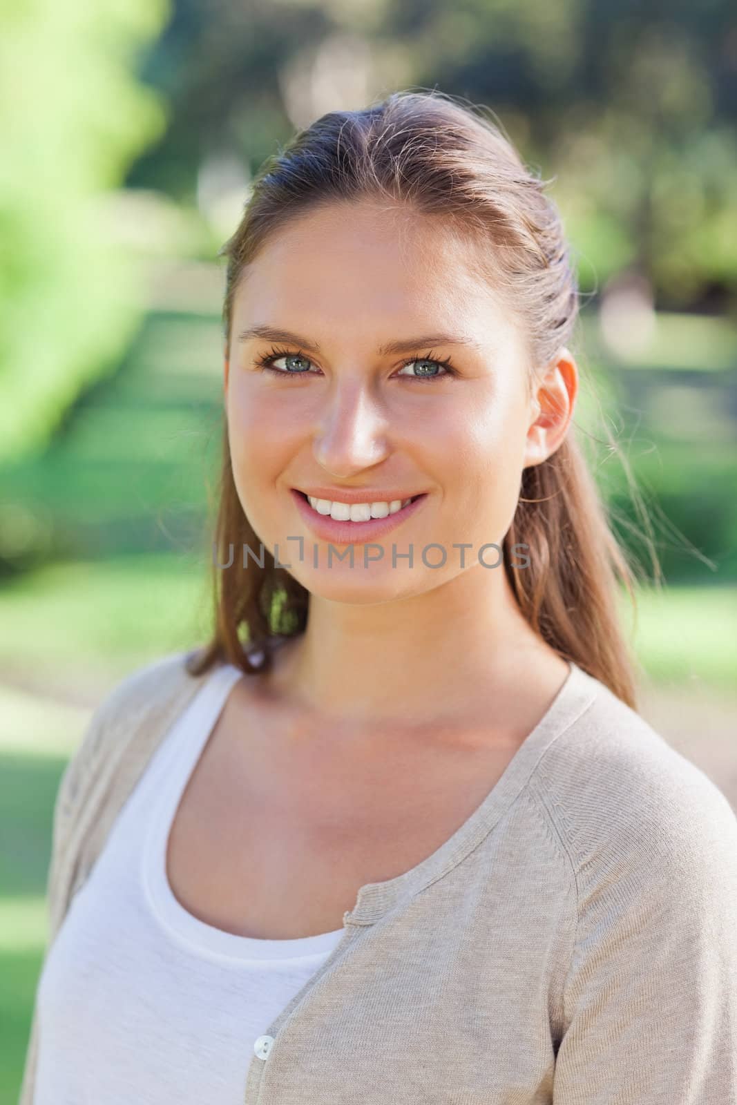 Close up of smiling young woman in the park