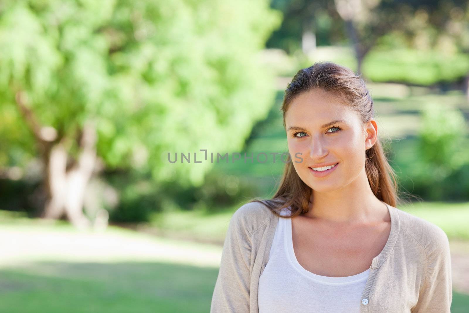 Smiling young woman spending her time in the country side