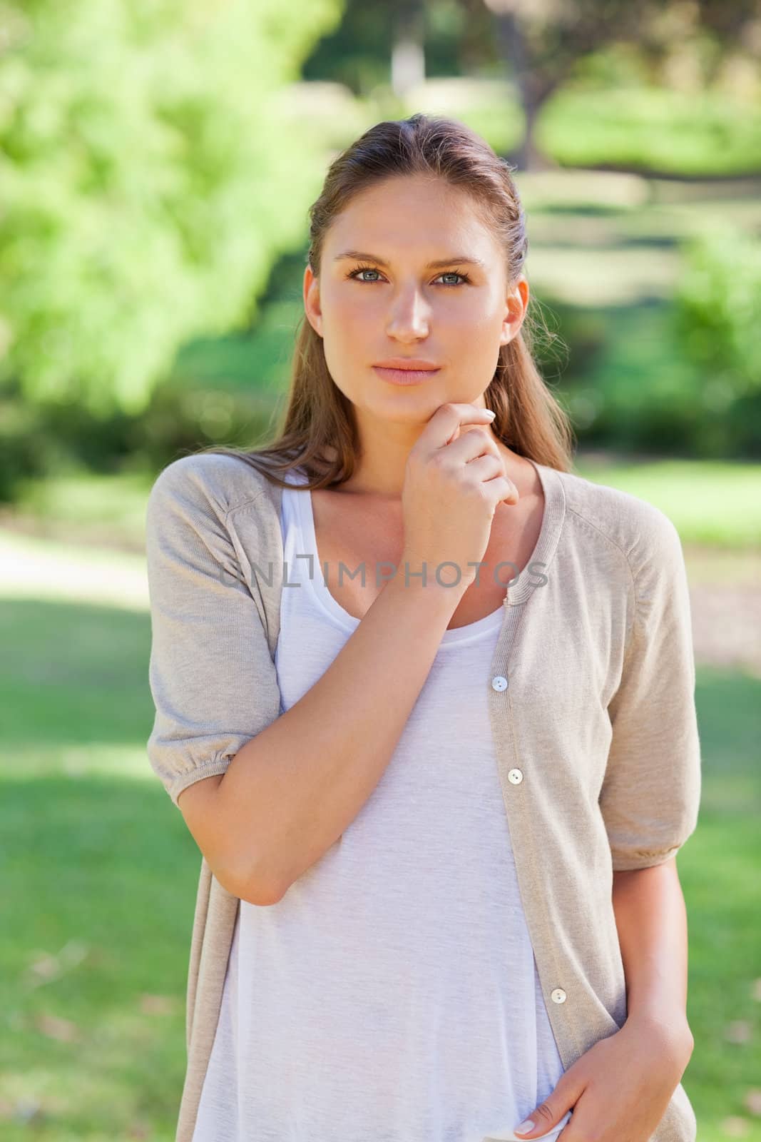 Thoughtful woman standing in the park by Wavebreakmedia