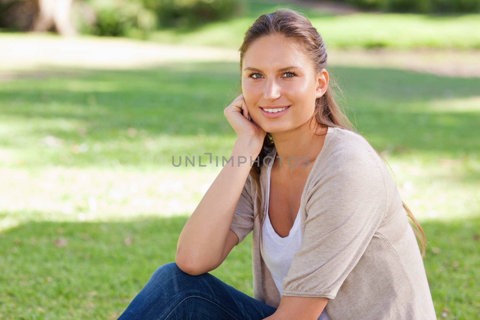 Relaxed young woman sitting on the lawn