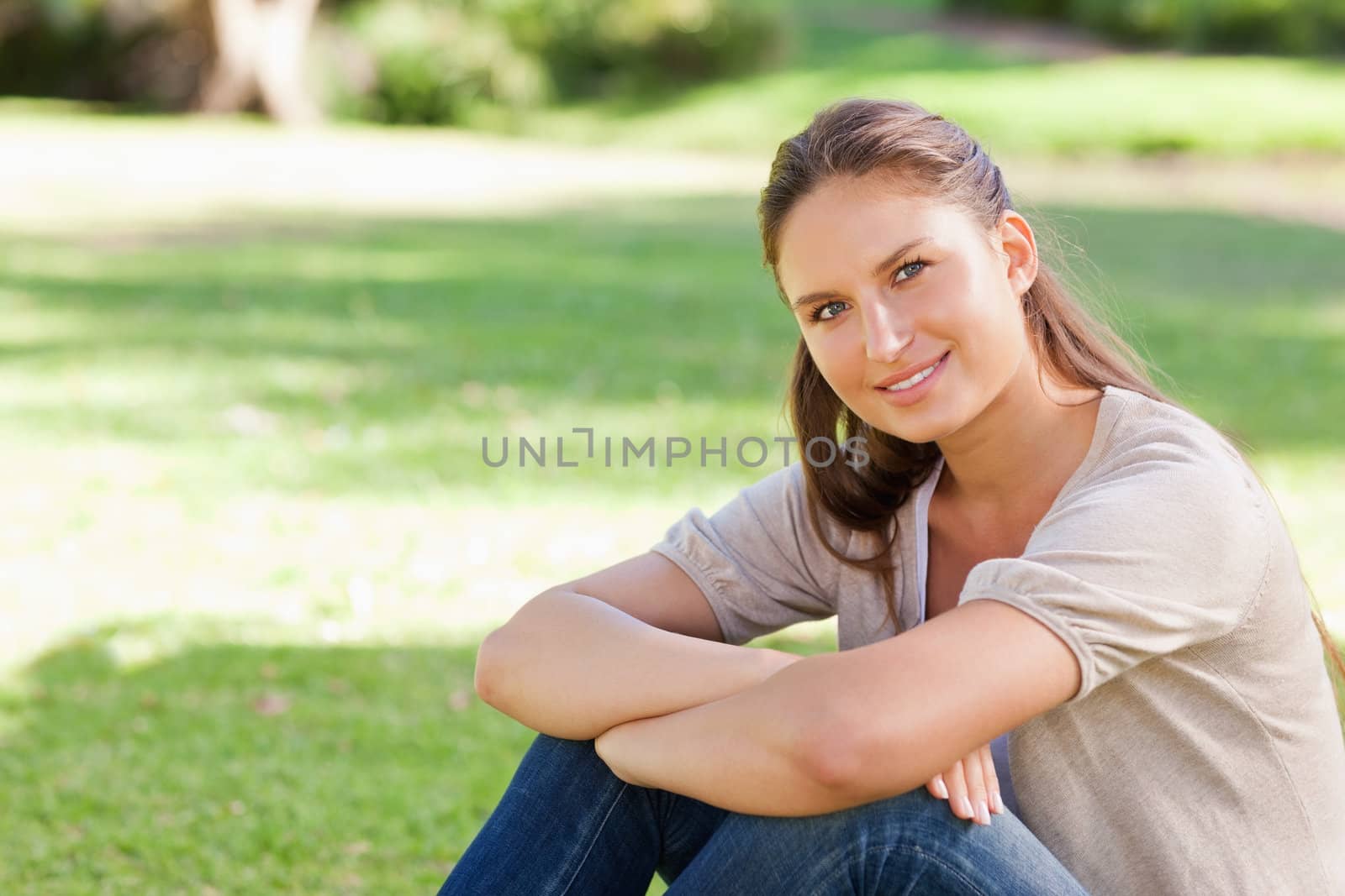 Smiling young woman relaxing in the park