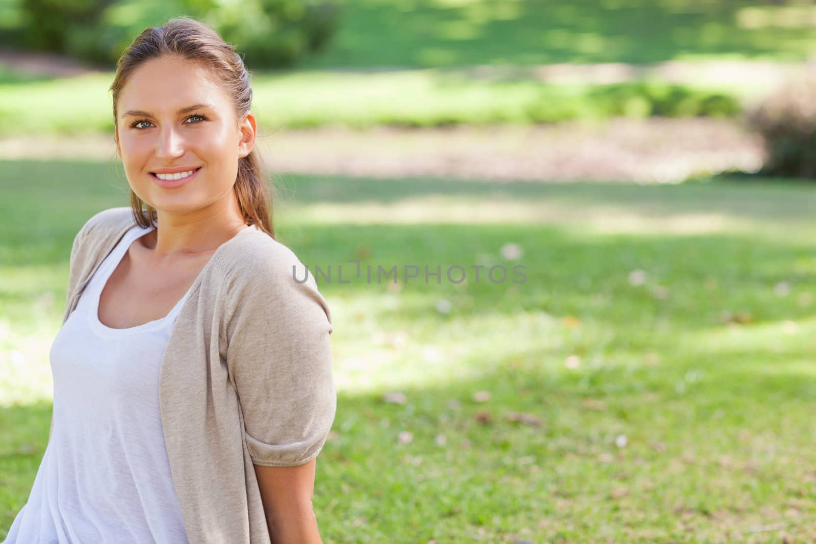 Smiling young woman enjoying her time in the park